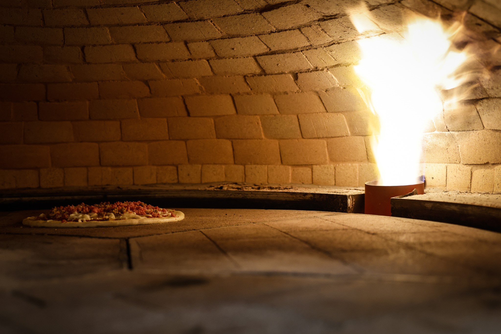 ILLY'S Fire Pizza features an open fire oven where Kelly and Robert Gunn make pizza at West Social Tap & Table located at 1100 West Third St. in Dayton. JIM NOELKER/STAFF