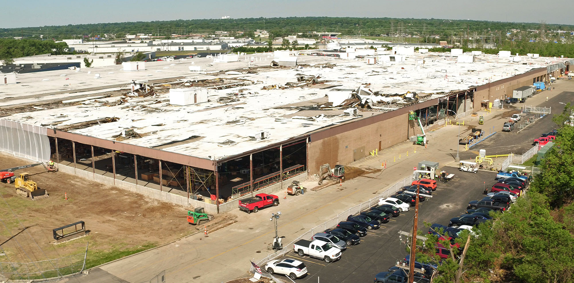 Aerial view looking northwest at the nearly 650,000 square foot Dayton Phoenix Group building on Kuntz Road in the Old North Dayton business park. The roof and walls were severely damaged by a tornado on Memorial Day.Construction workers are beginning restoration work. TY GREENLEES / STAFF