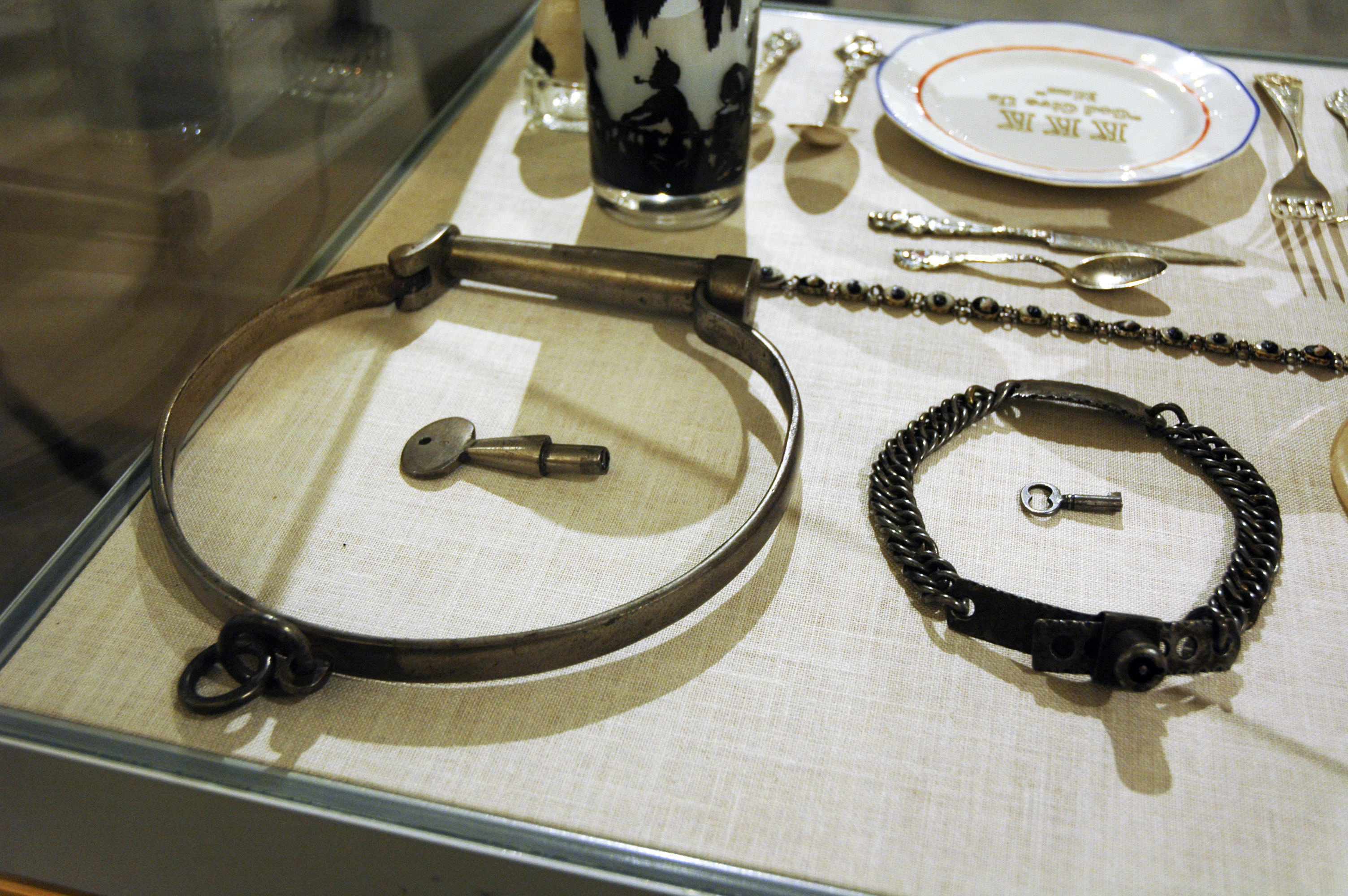 In this Jan. 11, 2018, photo, slave collars and a KKK plate, top right, are among the artifacts of slavery and segregation collected by Alan Page, NFL Hall of Famer and retired Minnesota Supreme Court justice, and his wife, Diane Sims Page. They went on display at the Minneapolis Central Library this month in time for Super Bowl visitors and thousands of other people expected to flock to downtown for the festivities. (AP Photo/Steve Karnowski)