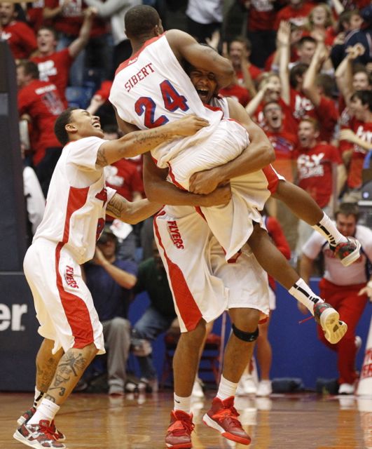 Devin Oliver picks up Jordan Sibert after Sibert's game-winning 3-pointer with 1 second left against IPFW on Saturday, Nov. 9, 2013, at UD Arena. Guard Kyle Davis is at left.