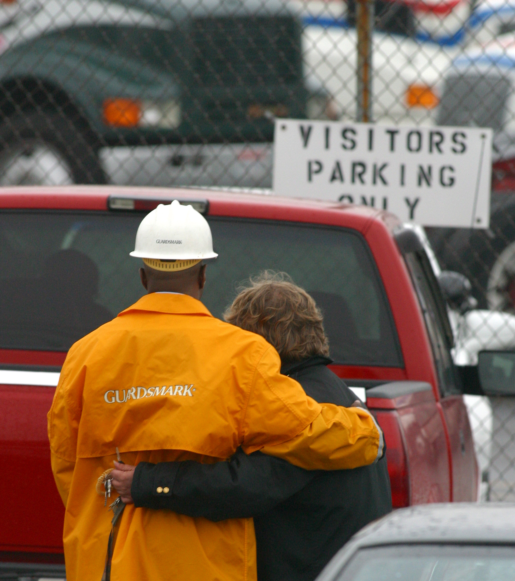 11-6-03 -- Security guards for Watkins Motor Lines in West Chester hug outside the trucking docks after two people were killed and three others injured inn a shooting rampage on Nov. 6, 2003. TY GREENLEES / STAFF
