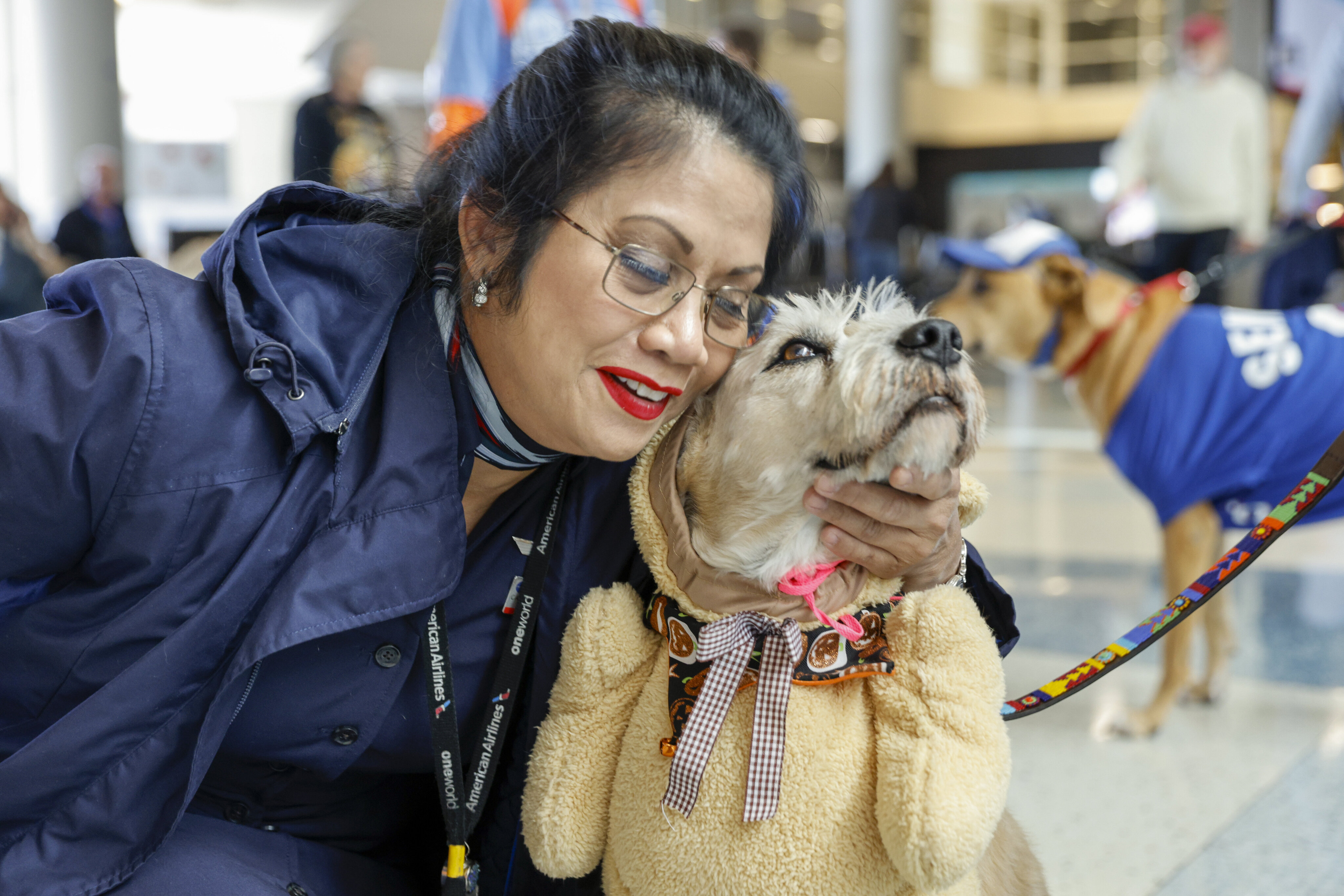 American Eagle flight attendant Carmel O. hugs Frankie an eight-year-old therapy dog at...