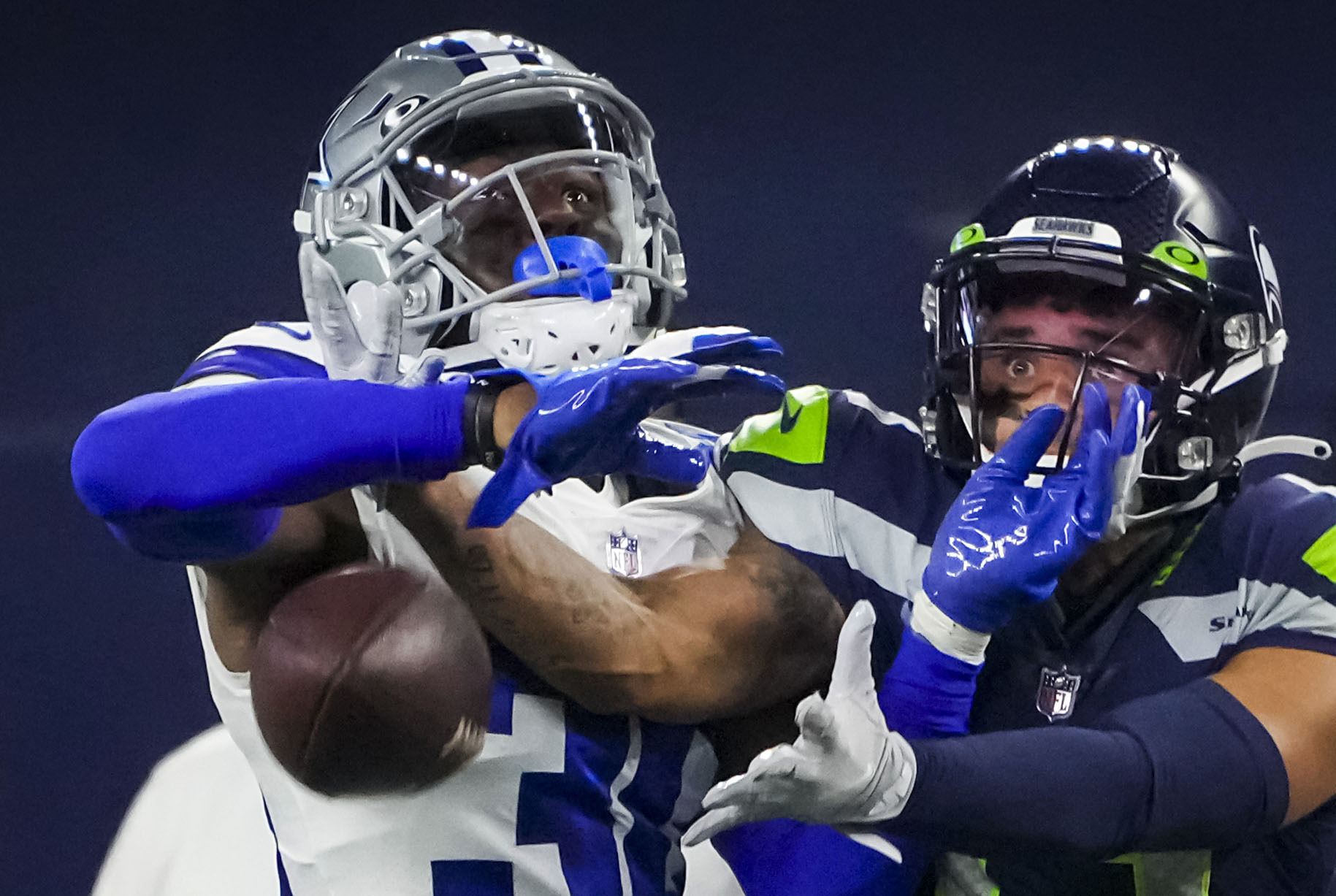 Dallas Cowboys cornerback Nahshon Wright, left, intercepts a pass by  quarterback Dak Prescott that was intended for wide receiver Jalen Tolbert  during the NFL football team's training camp Thursday, July 27, 2023