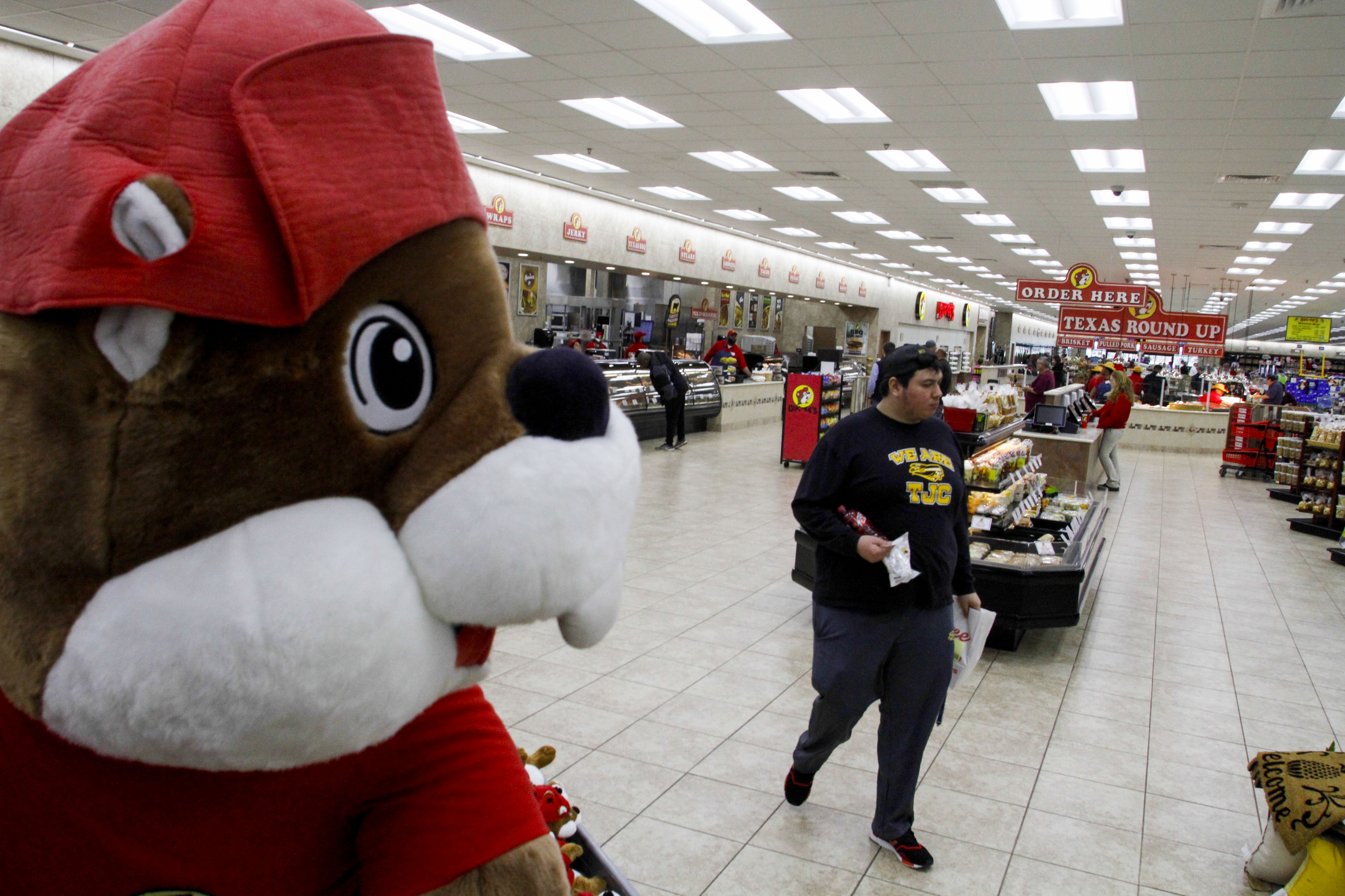 Jose Gonzalez walks by a large stuffed beaver at Buc-ee's in Terrell.