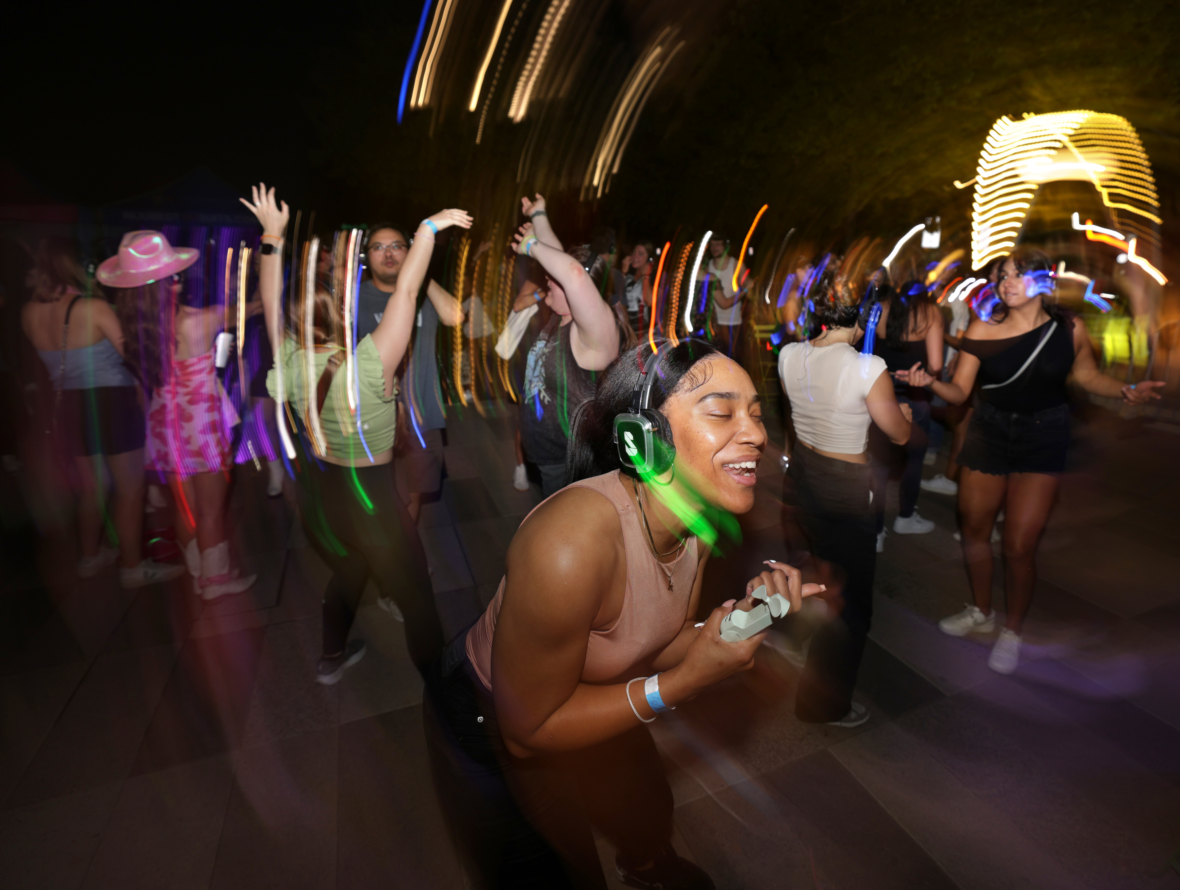 Guests participate in a Silent Disco event at Klyde Warren Park in Dallas on Sept. 6, 2024.