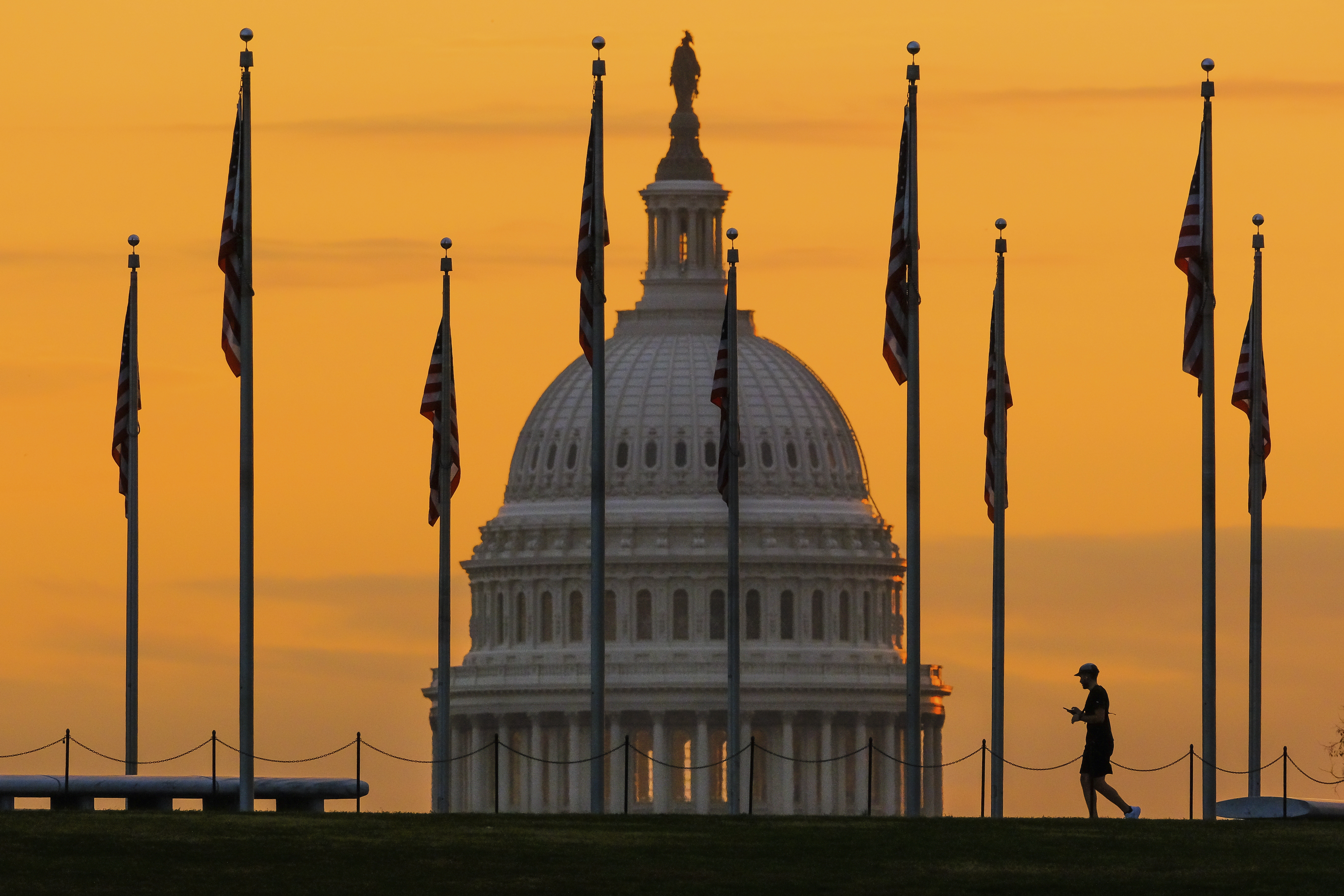 The U.S. Capitol Building looms behind flags on the National Mall in Washington in 2022....