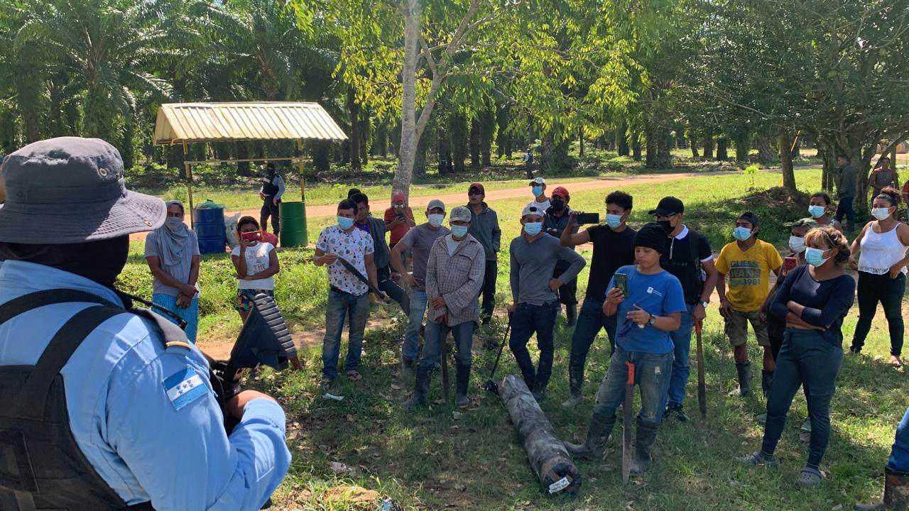 This photo, supplied by the author, shows police confronting trespassers armed with machetes...