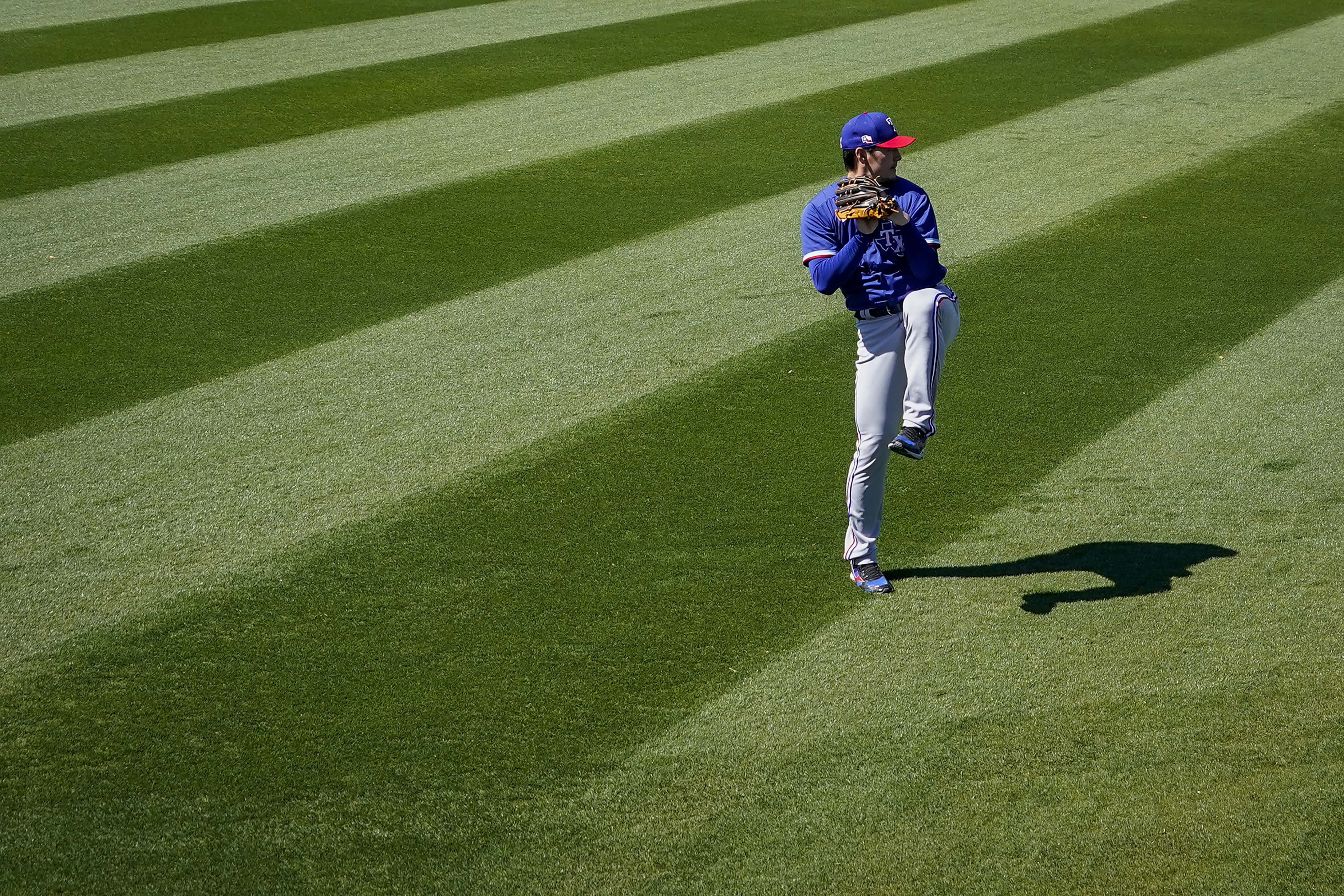 Texas Rangers third baseman Brock Holt (16) blows a bubble during