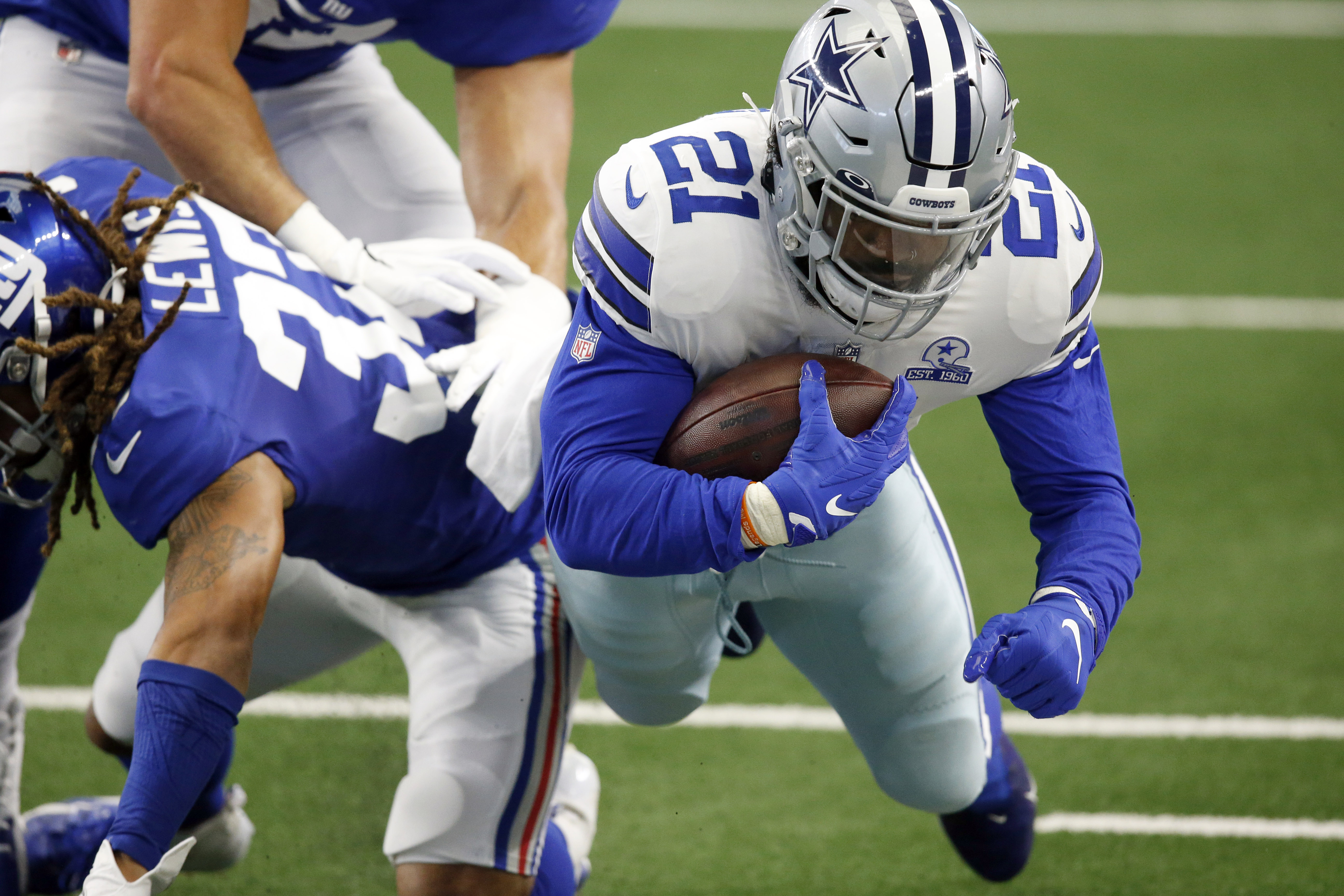 Dallas Cowboys running back Ezekiel Elliott (21) celebrates with Dallas  Cowboys quarterback Dak Prescott (4) after