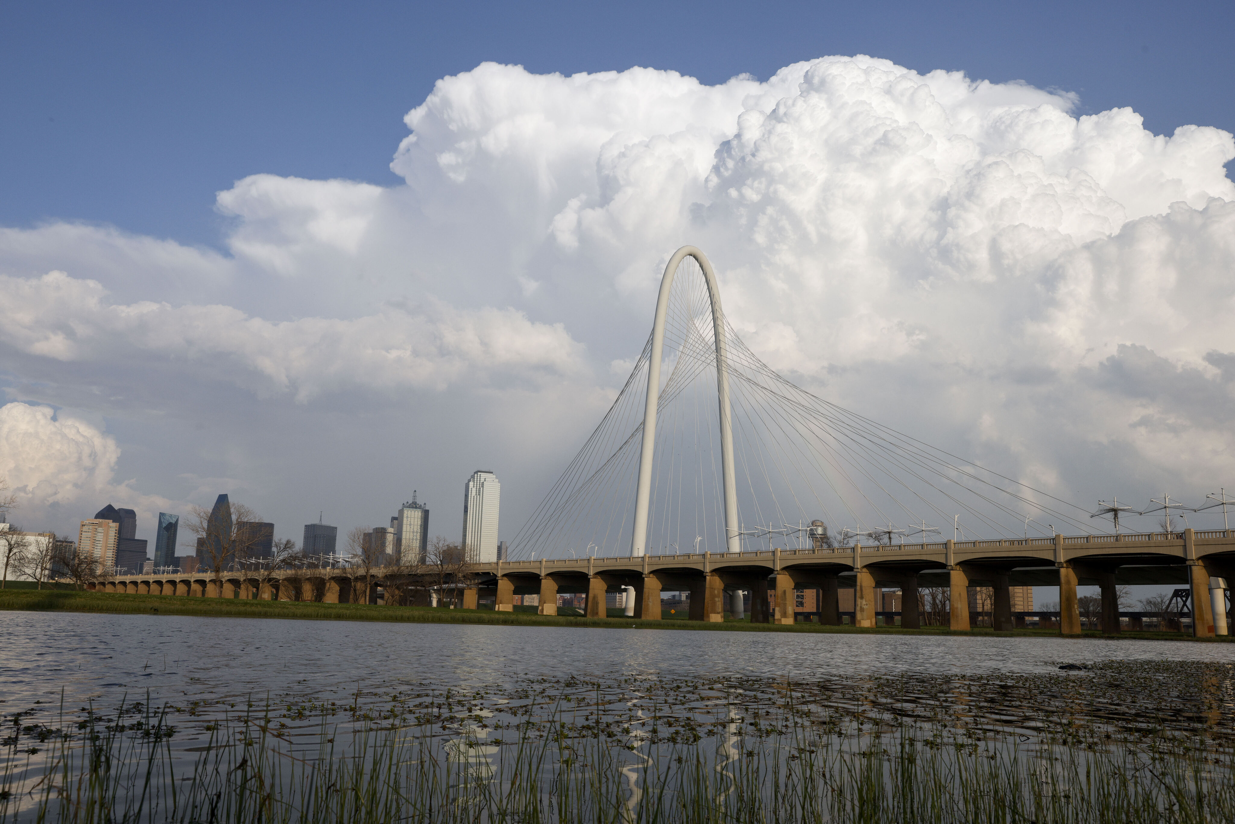 Storm clouds rise over the Margaret Hunt Hill Bridge and downtown Dallas.