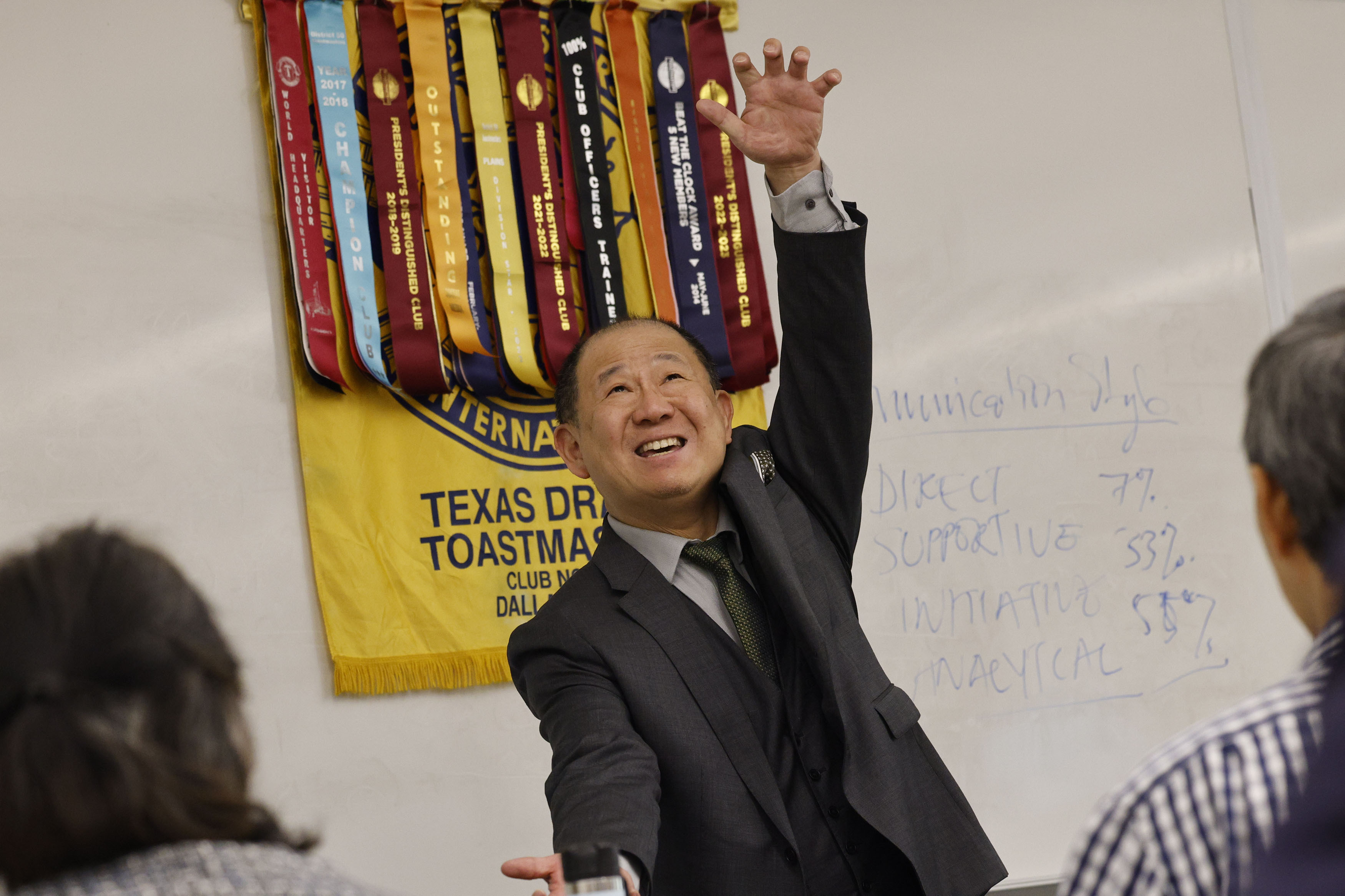 Yujun Liang delivers a speech during a Texas Dragon Toastmasters Club meeting at the...