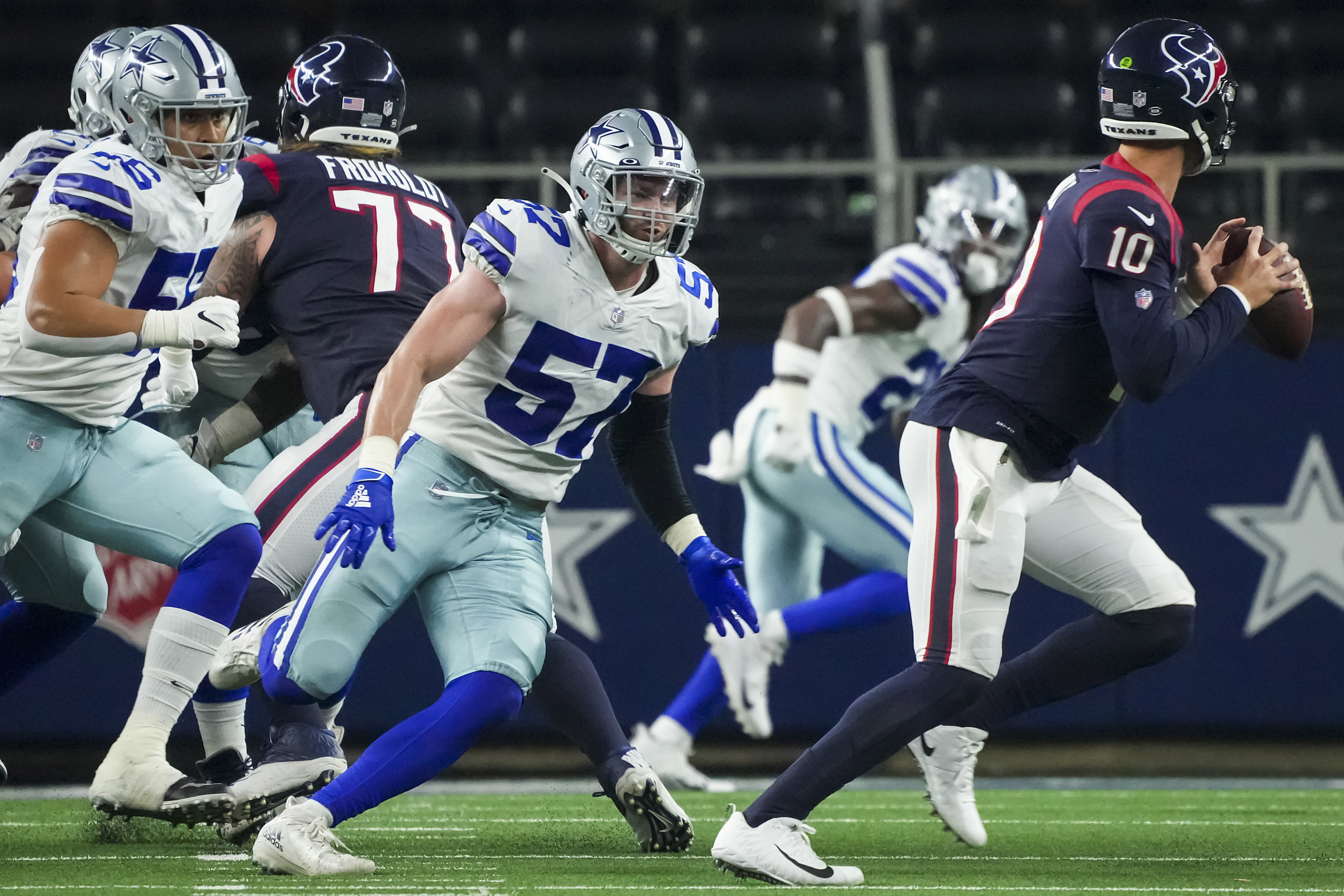 Dallas Cowboys' Terence Steele, left, Zack Martin (70), Connor McGovern  (66) and others celebra …