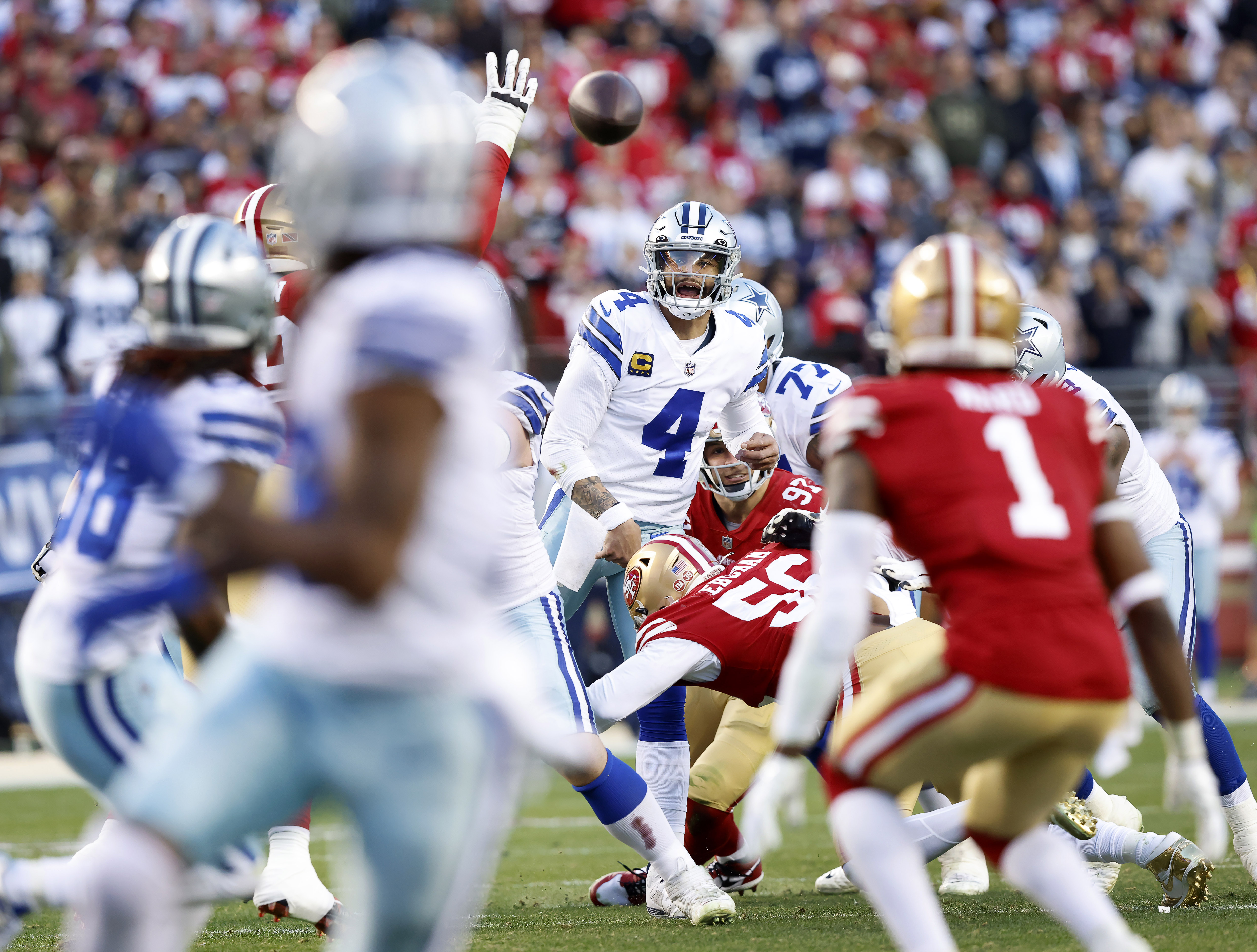 San Francisco 49ers linebacker Fred Warner (54) and Dallas Cowboys wide  receiver CeeDee Lamb (88) after a stop during an NFL divisional round  playoff football game, Sunday, Jan. 22, 2023, in Santa