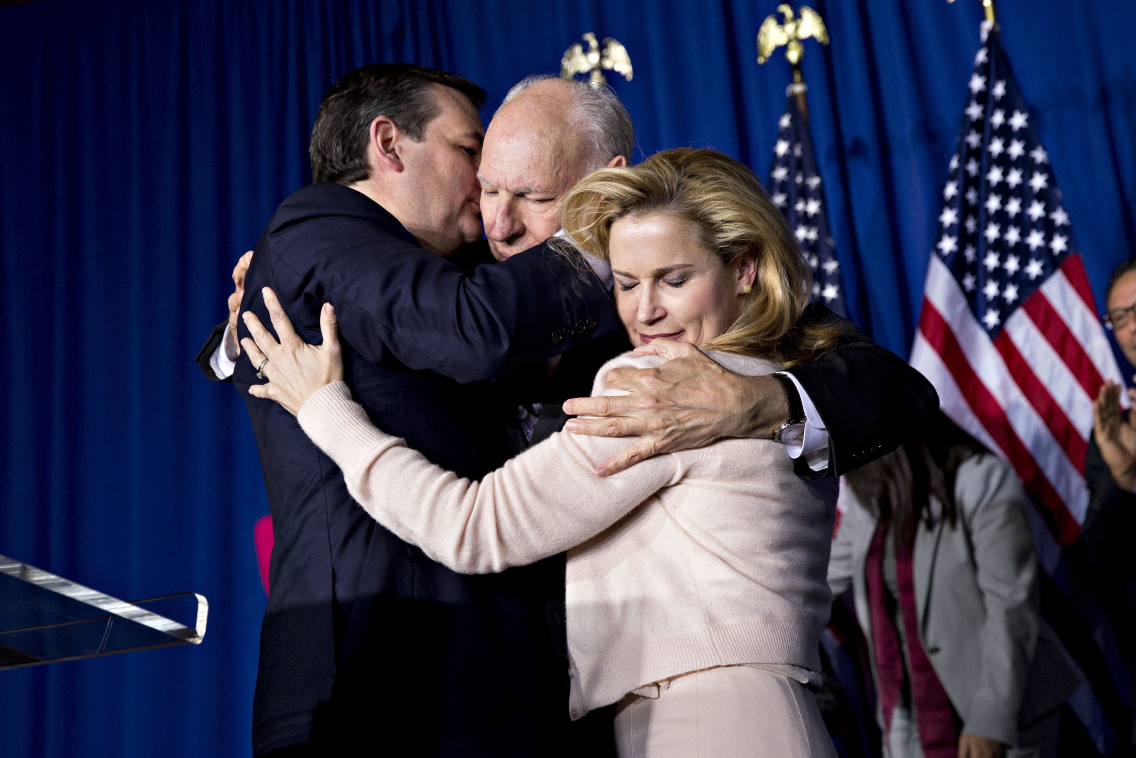 Sen. Ted Cruz embraces his father, Rafael Cruz, and wife Heidi after suspending his...