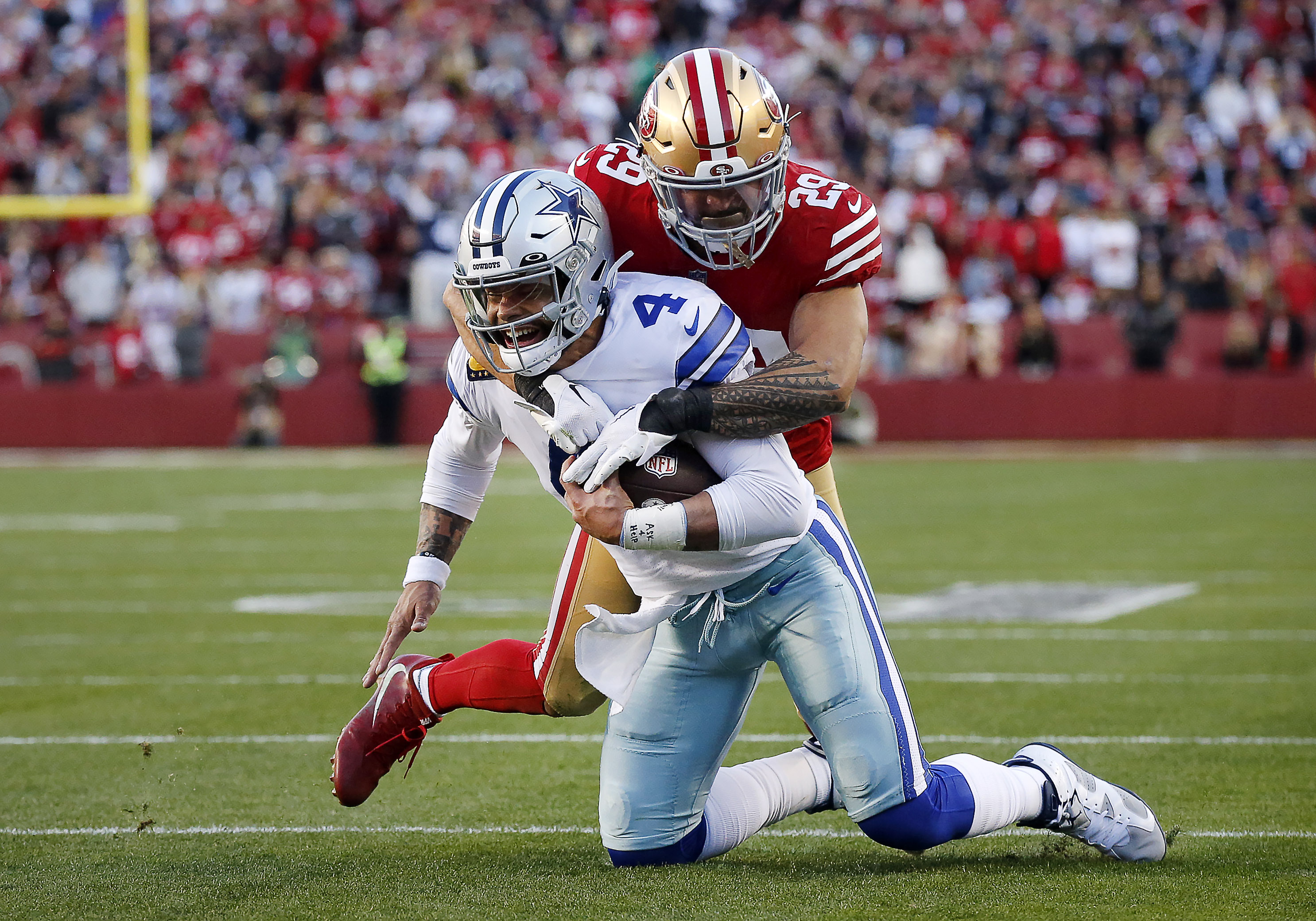 San Francisco 49ers linebacker Fred Warner (54) and Dallas Cowboys wide  receiver CeeDee Lamb (88) after a stop during an NFL divisional round  playoff football game, Sunday, Jan. 22, 2023, in Santa