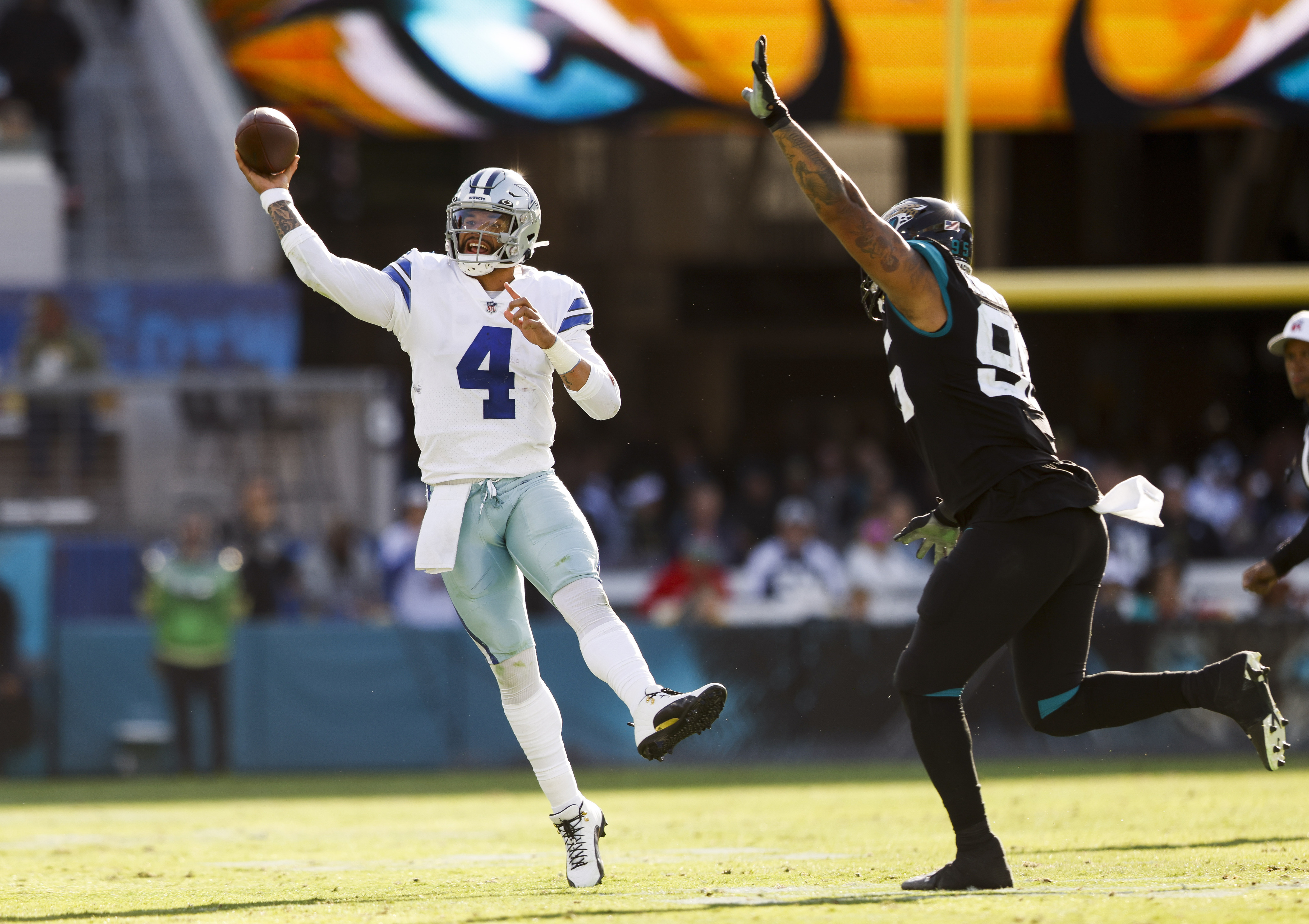 Dallas Cowboys quarterback Dak Prescott (4) alongside Tyron Smith (77)  during a Thanksgiving day NFL football game against the Las Vegas Raiders,  Thursday, Nov. 25, 2021, in Arlington, Texas. (AP Photo/Matt Patterson