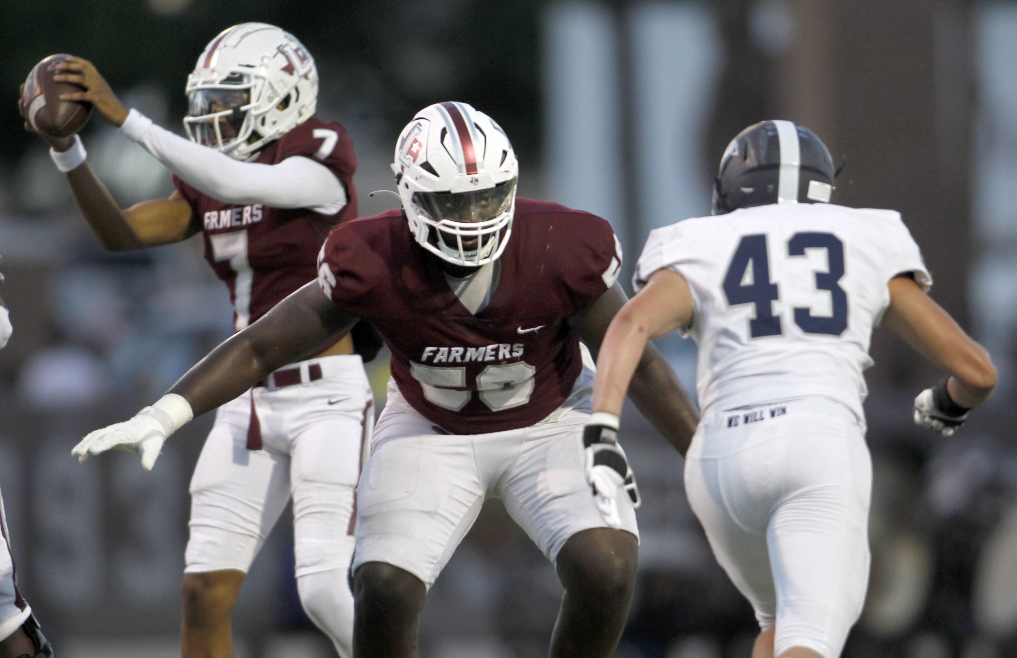 Lewisville offensive lineman Michael Fasusi (56), center, protects quarterback Ethan Terrell...