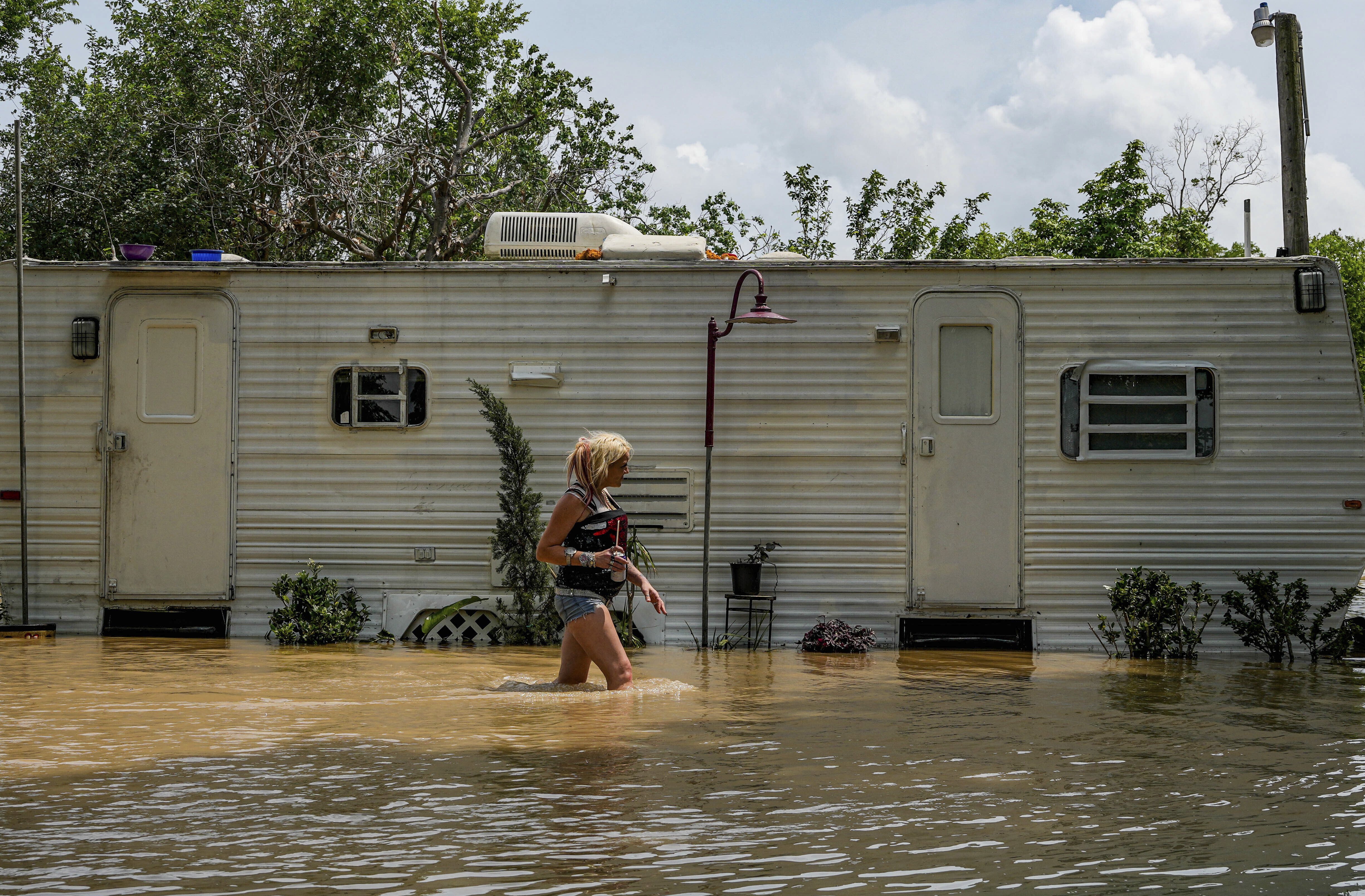 A woman, who only gave her name as Lisamarie, checks on an elderly resident inside his RV...