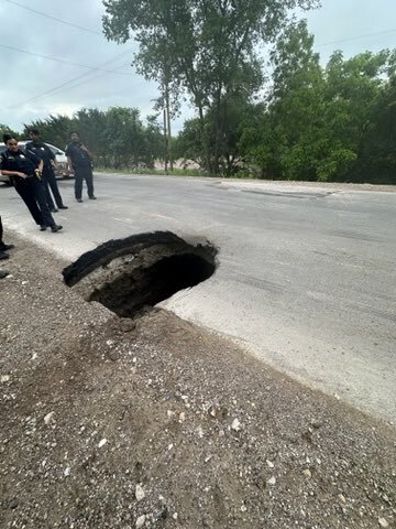A large sinkhole opened Friday morning in Dallas County, shutting down a road.