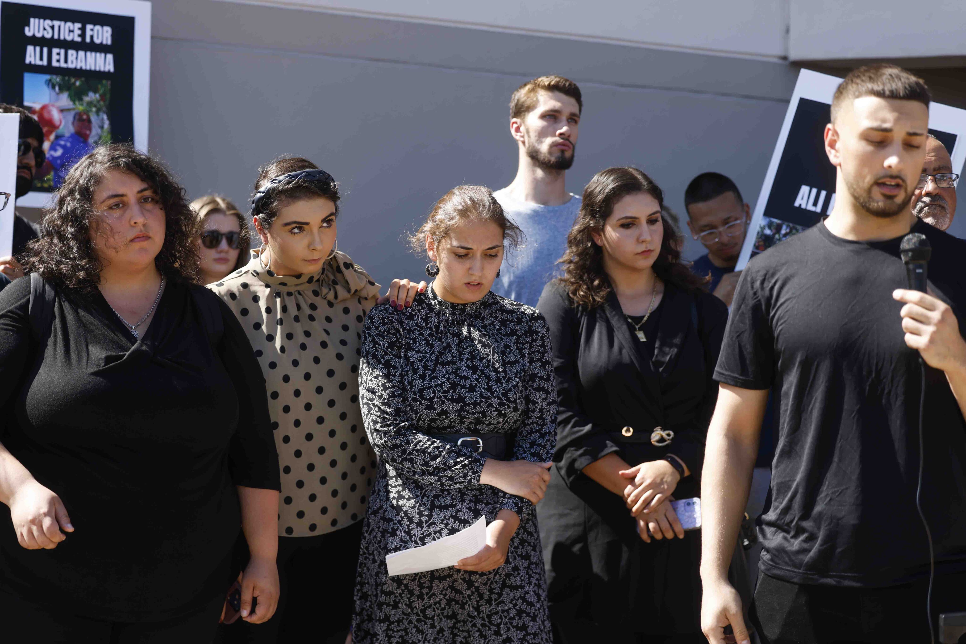 Sayed Elbanna, far right, son of victim Ali Elbanna speaks as his daughters, from left,...