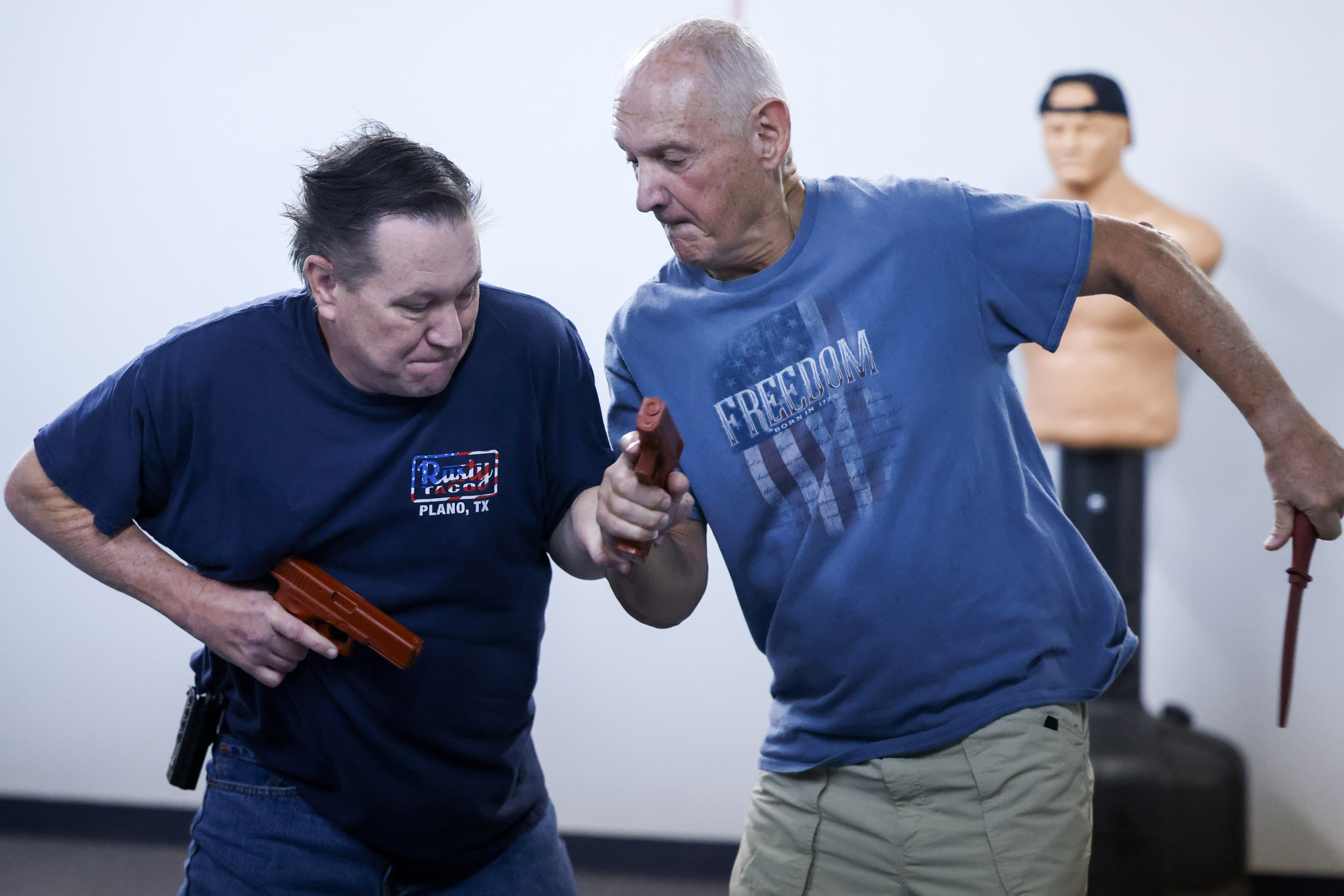 Kevin Livesey (left) and Charlie LaShure of Life Fellowship Church take part in weapon...