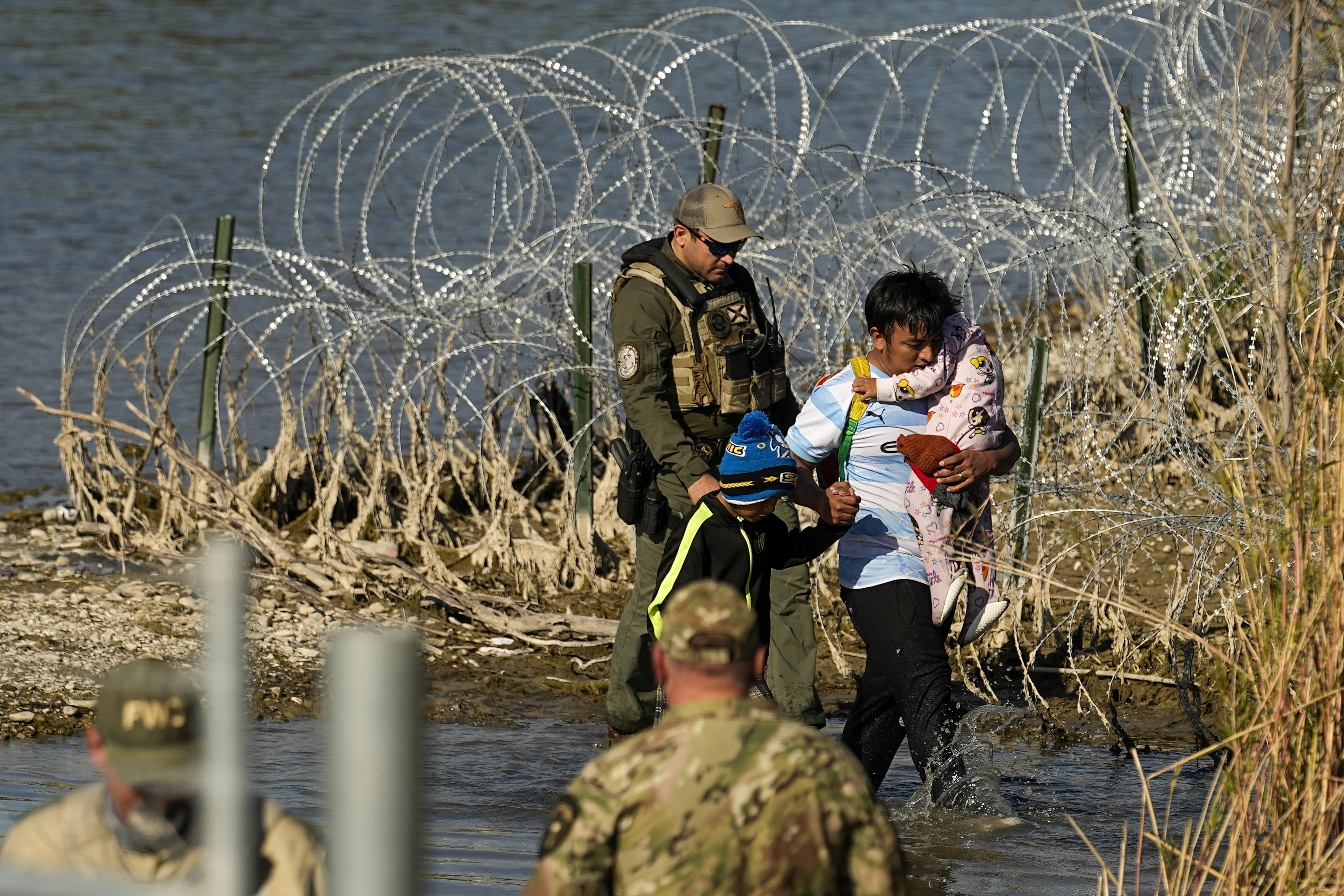 Migrants were taken into custody by officials at the Texas-Mexico border in Eagle Pass on...