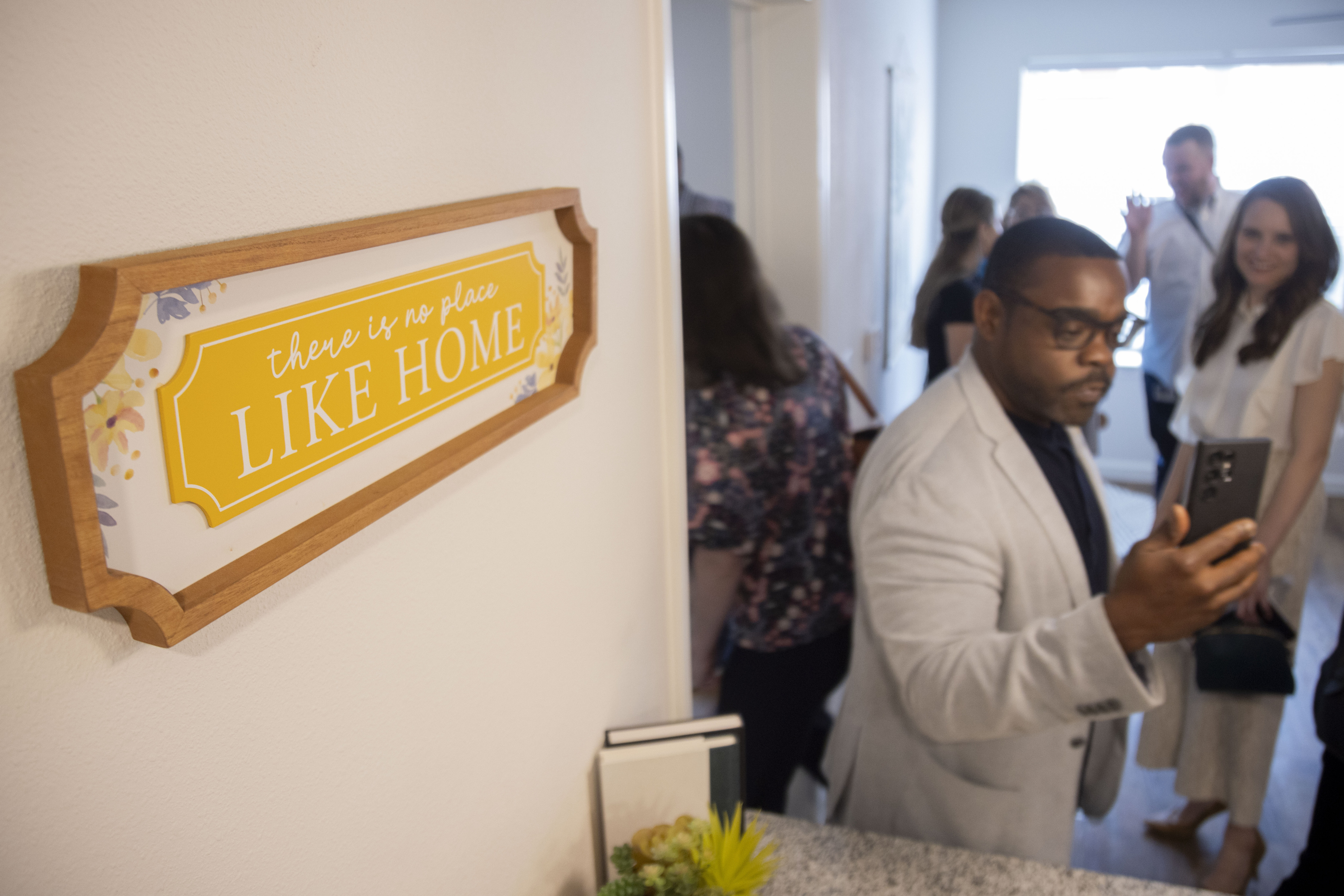 Dallas City Council member Zarin Gracey takes photos of a two bedroom unit while touring it...