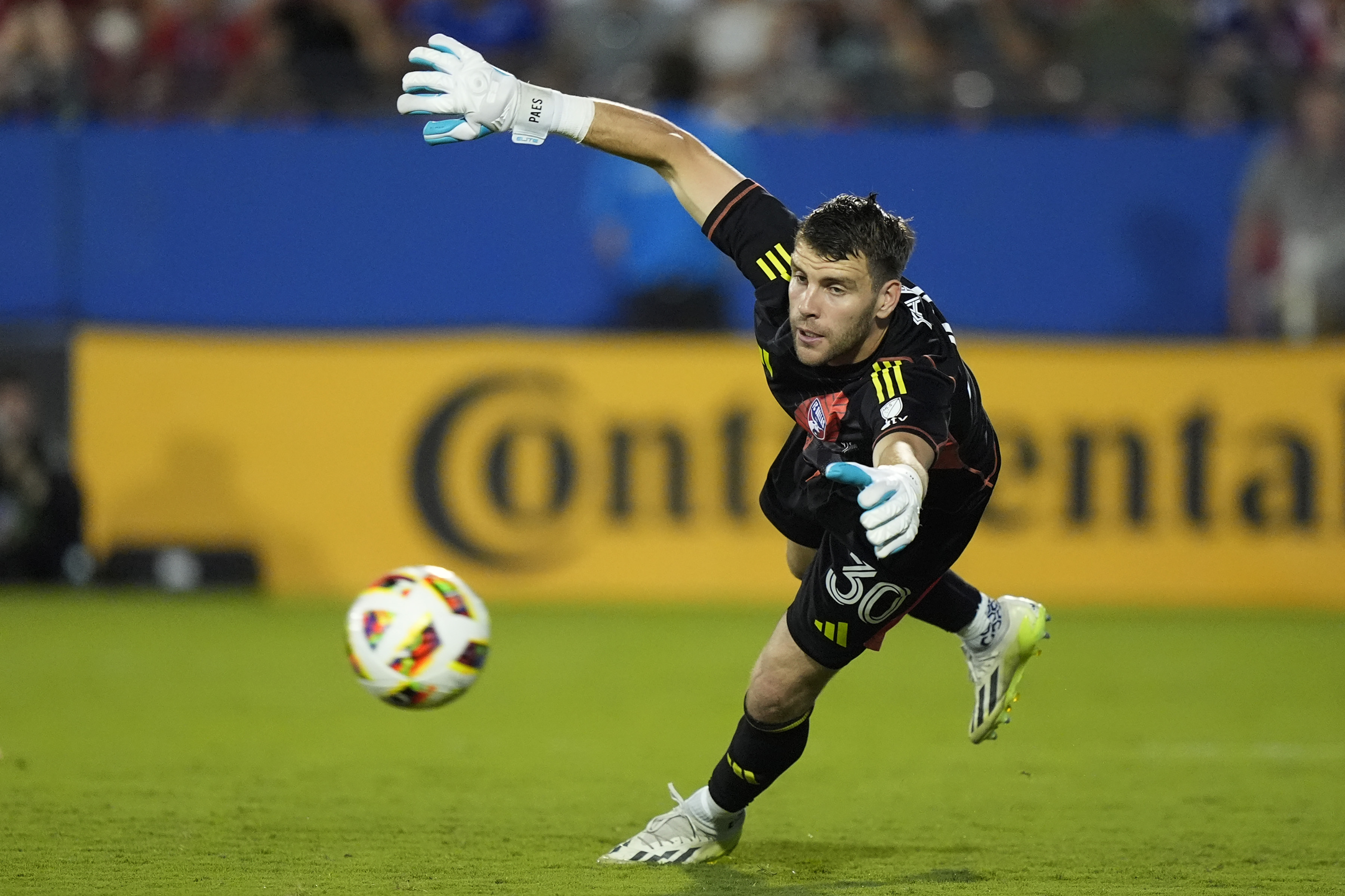 FC Dallas goalkeeper Maarten Paes reaches for a shot during the second half of an MLS soccer...