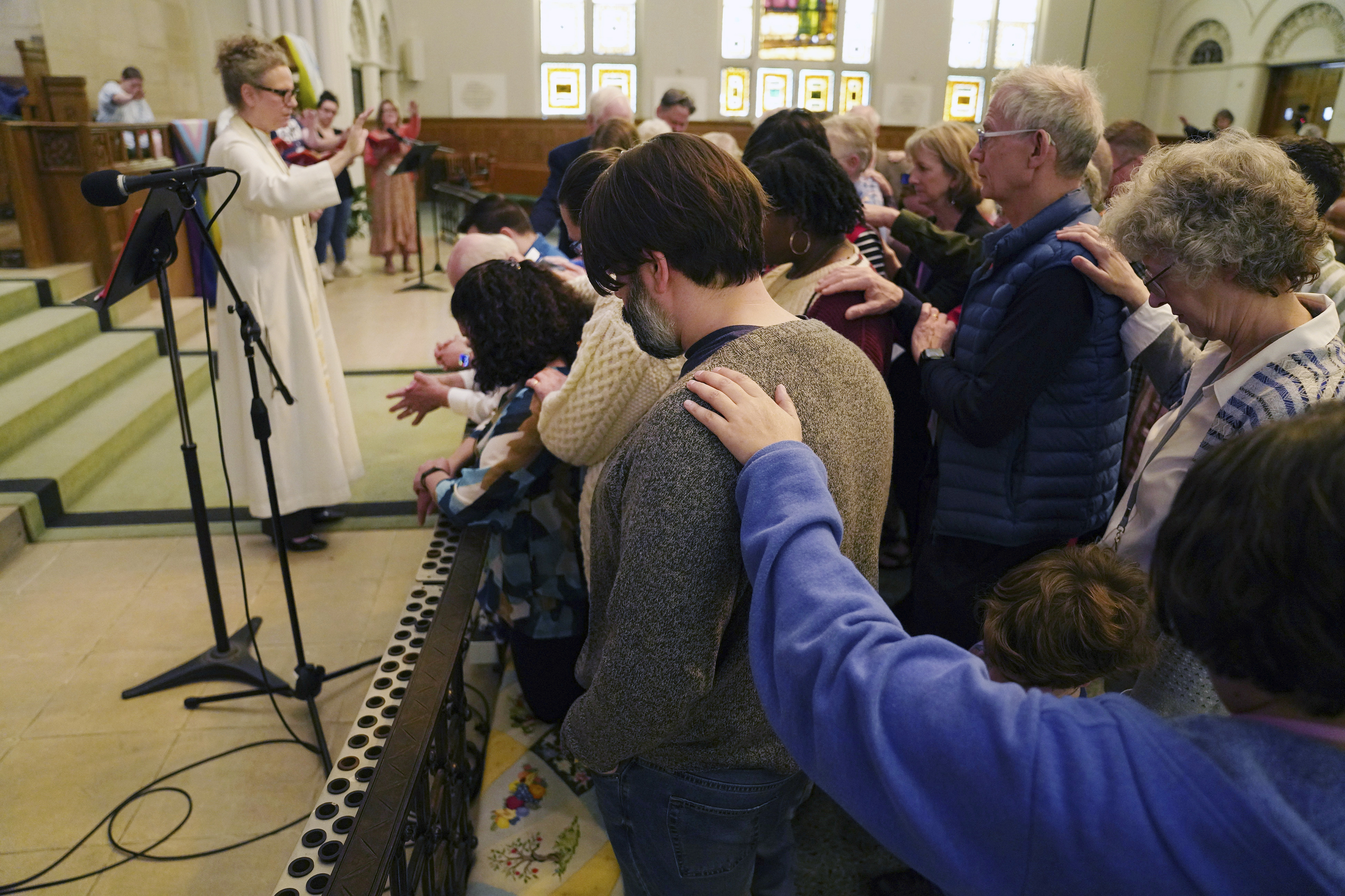The Rev. Tracy Cox of First United Methodist Church, left, and members of her congregation...