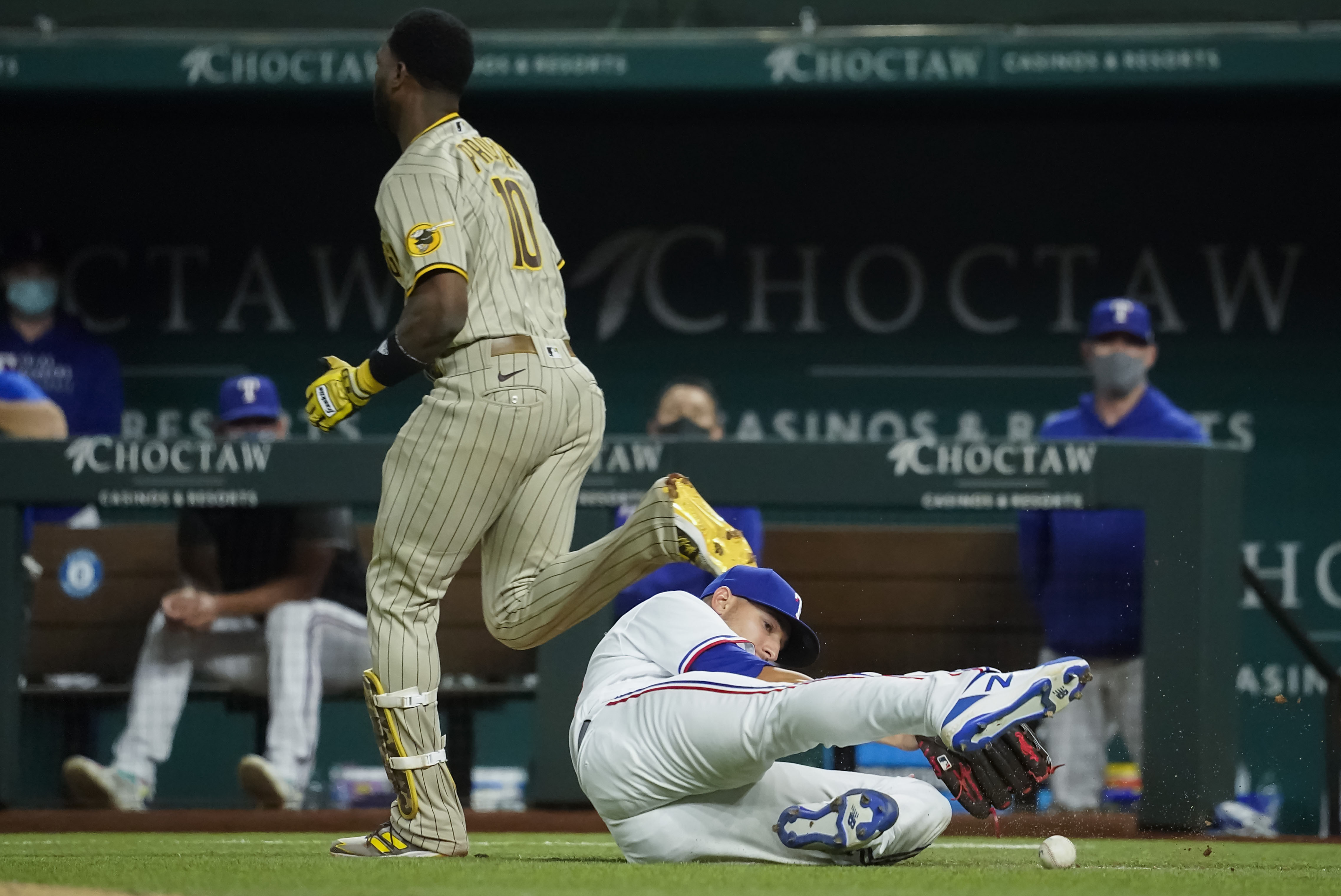 San Diego Padres' Manny Machado blows a gum bubble while watching