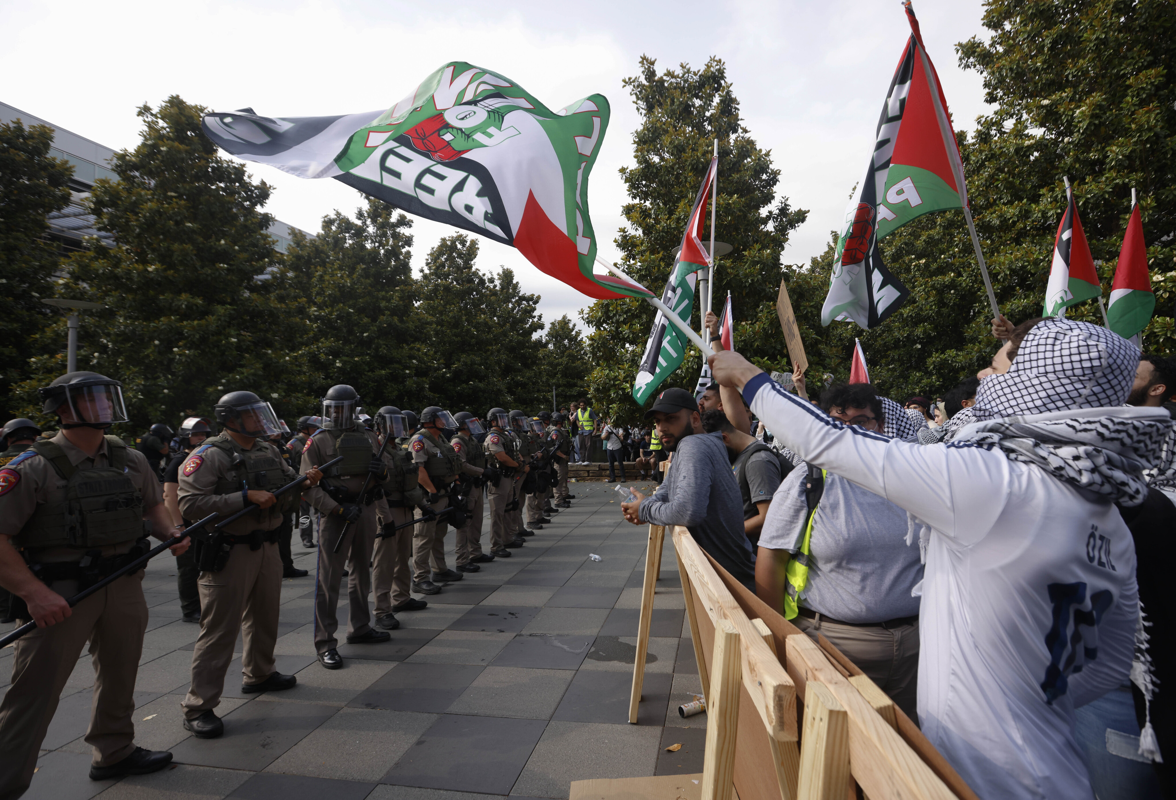 Protestors chant as law enforcement dismantle an encampment by pro-Palestinian students at...