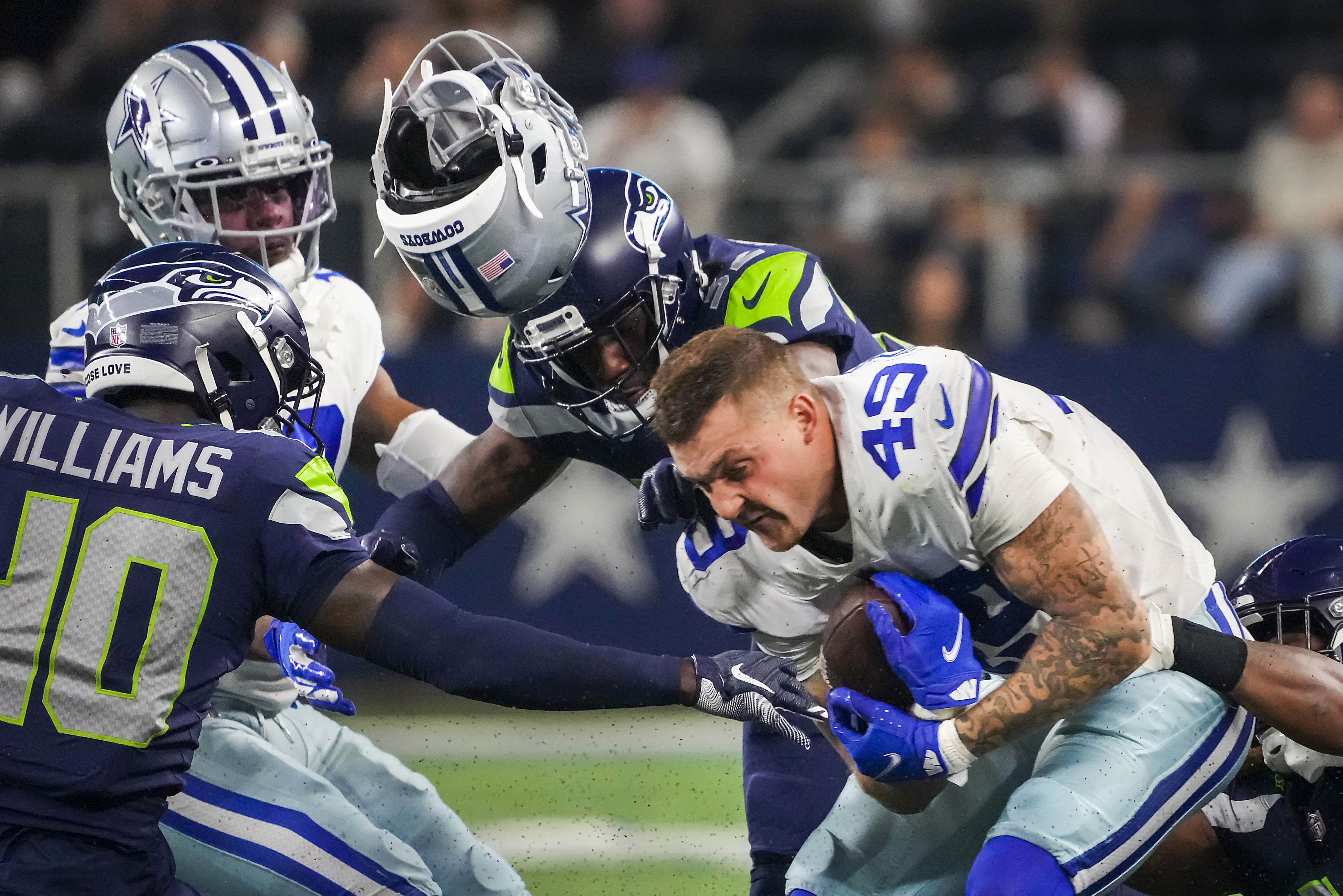 Dallas Cowboys cornerback Nahshon Wright, left, intercepts a pass by  quarterback Dak Prescott that was intended for wide receiver Jalen Tolbert  during the NFL football team's training camp Thursday, July 27, 2023