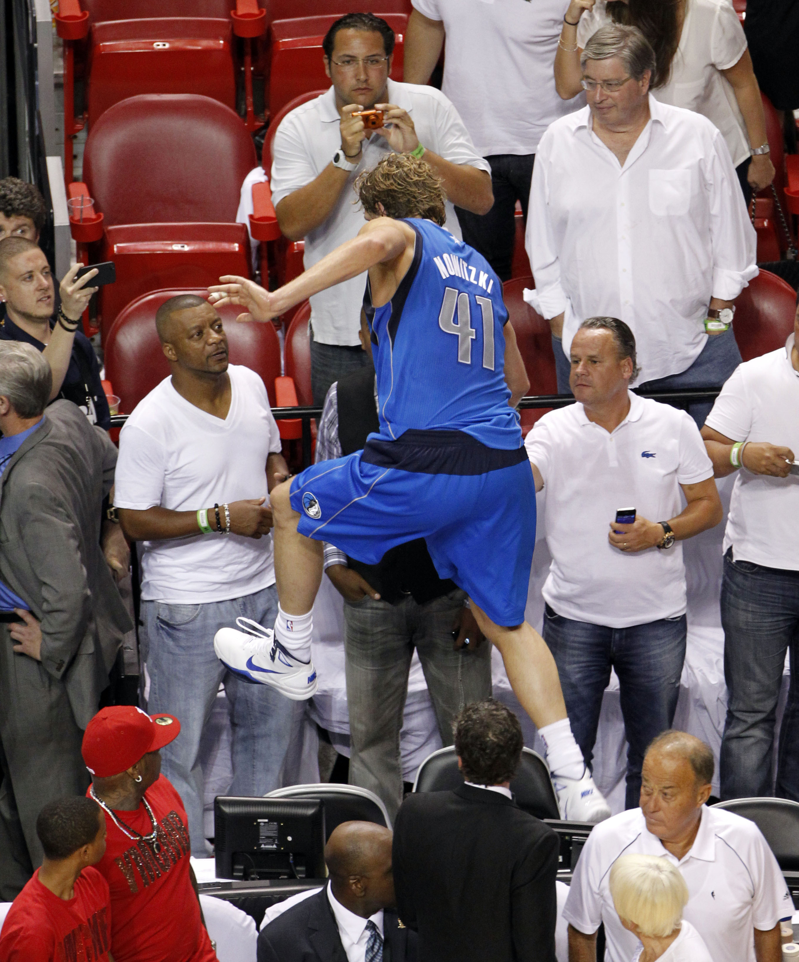 Dirk Nowitzki of the Mavericks holds the championship trophy after  defeating the Heat during Game 6 of the NBA Finals at the AmericanAirlines  Arena in Miami, Florida, Sunday, June 12, 2011. The