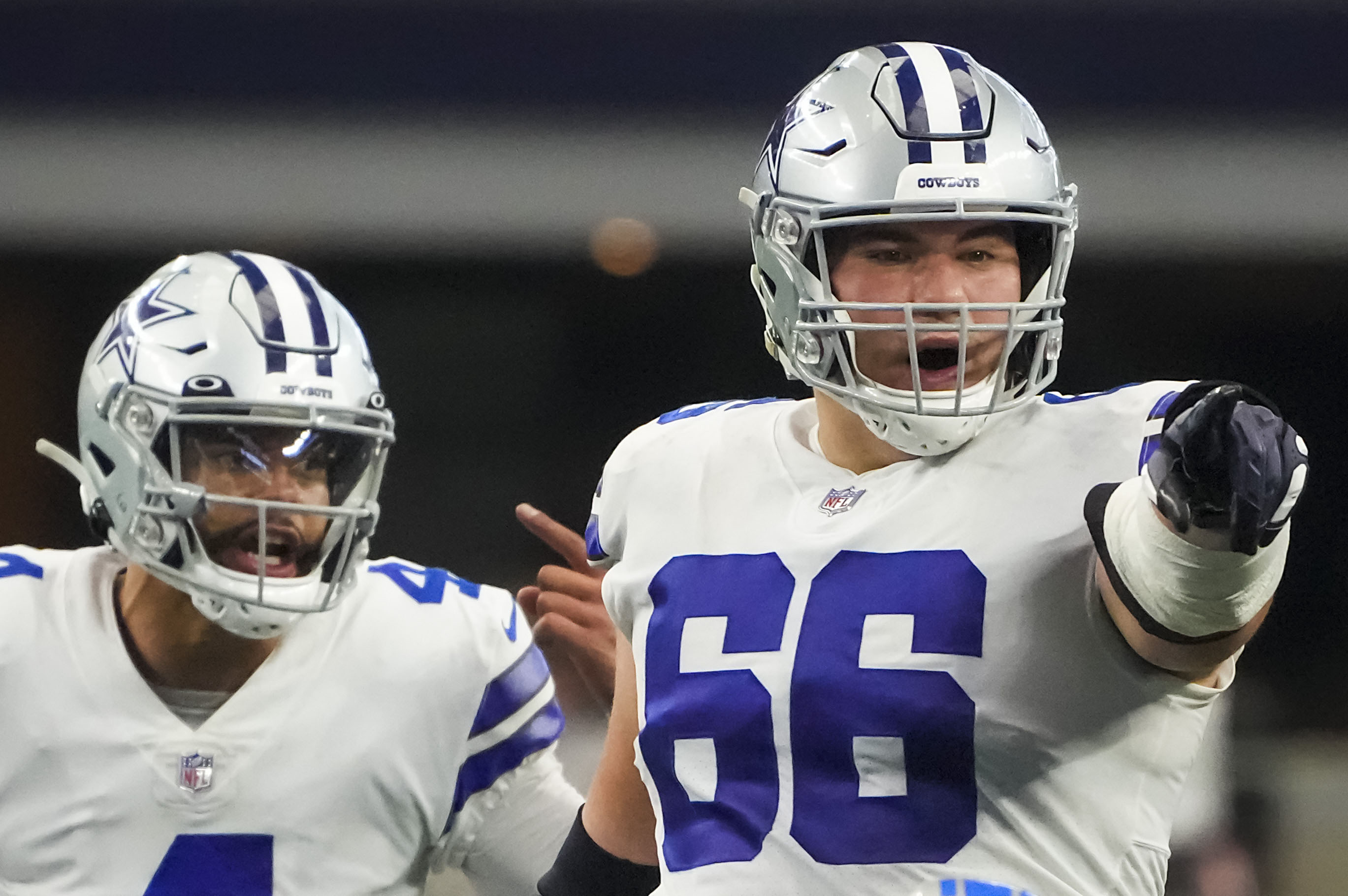 Dallas Cowboys guard Connor McGovern (66) is helped off the field by team  medical staff after suffering an unknown injury in the first half of a NFL  football game against the Tampa