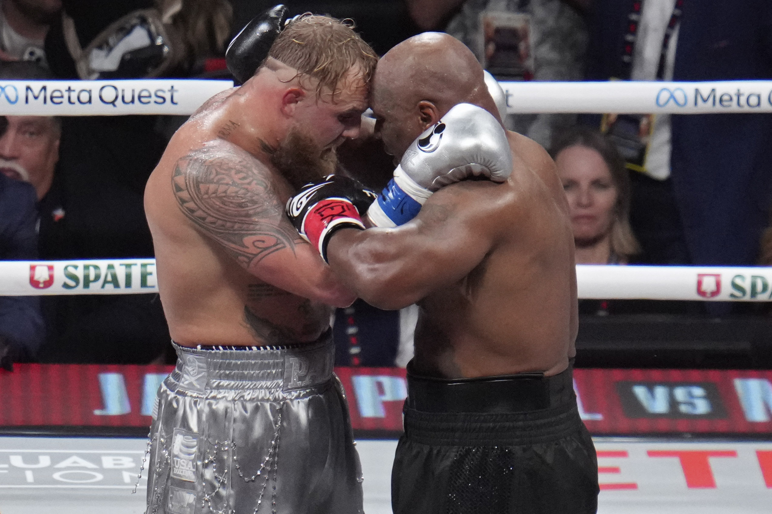 Jake Paul and Mike Tyson embrace after their heavyweight boxing match, Friday, Nov. 15,...