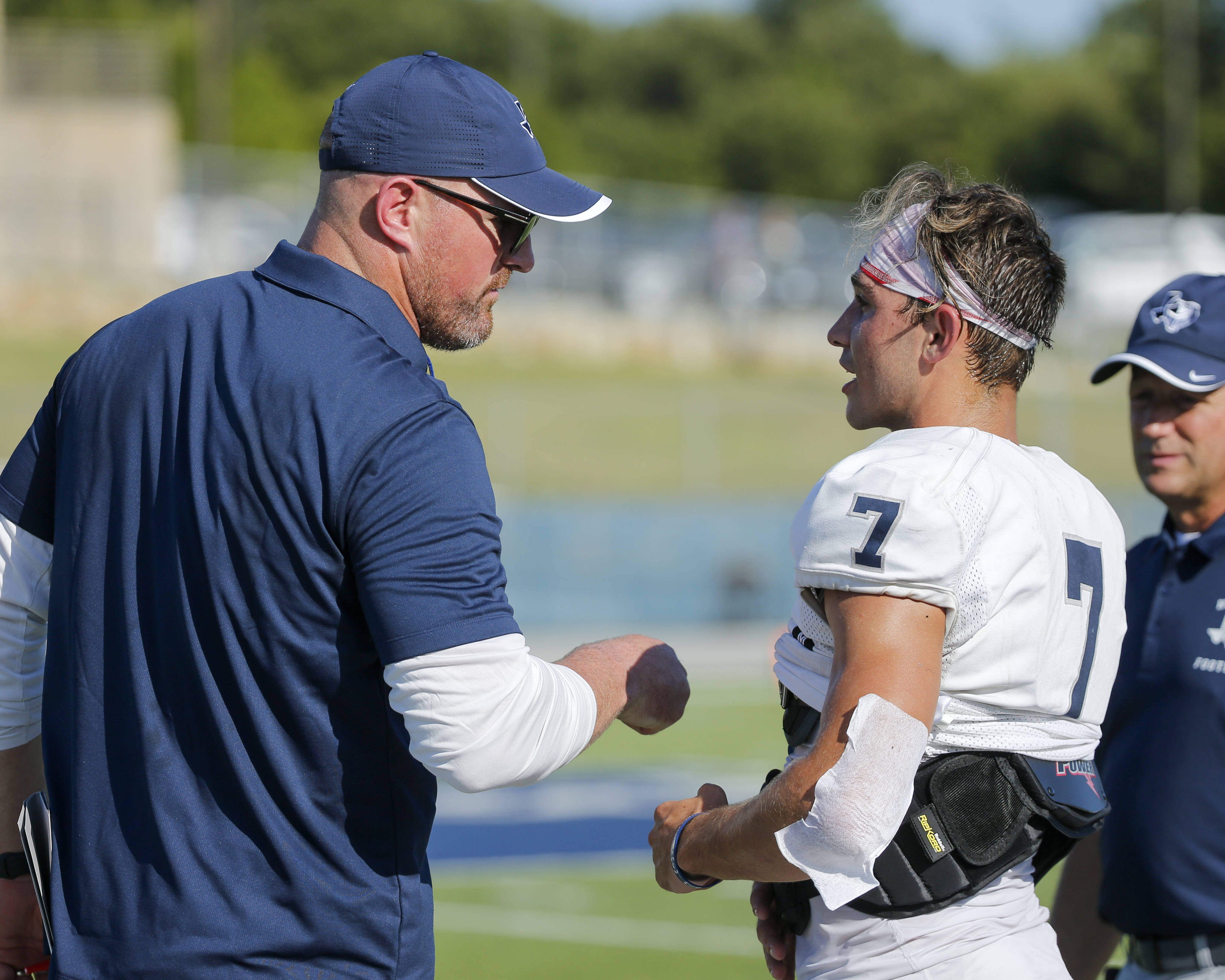 Liberty Christian head coach Jason Witten encourages his team in