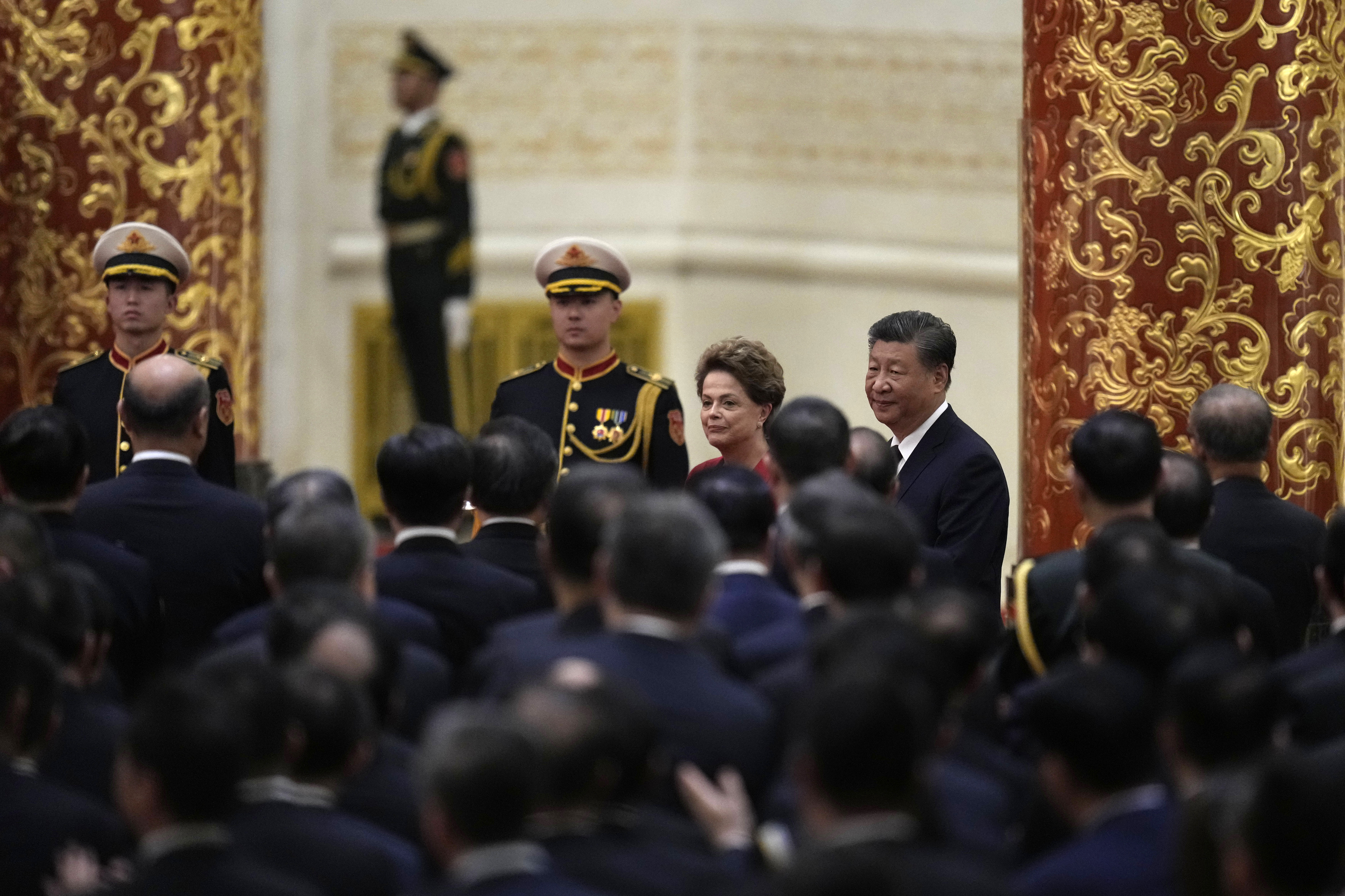 Chinese President Xi Jinping (center right) walks with Brazil's former President and...