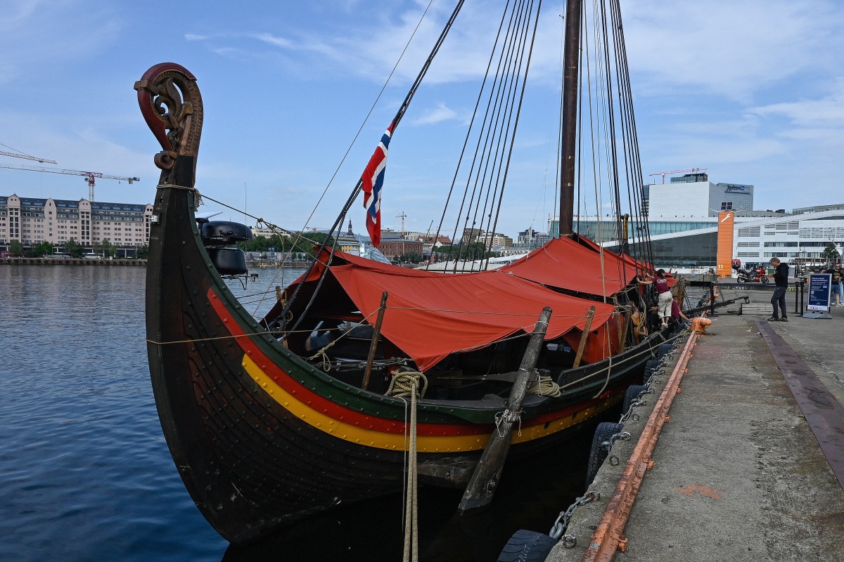 The Draken Harald Harfagre (the ship used in the movie the Odyssey) is docked outside Oslo Opera in the Norwegian capital on August 14, 2026. Ulysses on a Viking ship? Two millennia separate the two worlds. Yet it�s precisely on board such a vessel that Christopher Nolan has the Greek hero sail in �The Odyssey,� a deliberate anachronism in the service of realism. With its tar-soaked ropes, creaking oak deck, and fifty slender spruce oars, the Draken Harald H�rfagre, the largest modern replica of a Viking ship, has, for the duration of a film shoot, swapped the fantasy of Scandinavian sagas for that of Greek mythology. (Photo by Jonathan KLEIN / AFP)