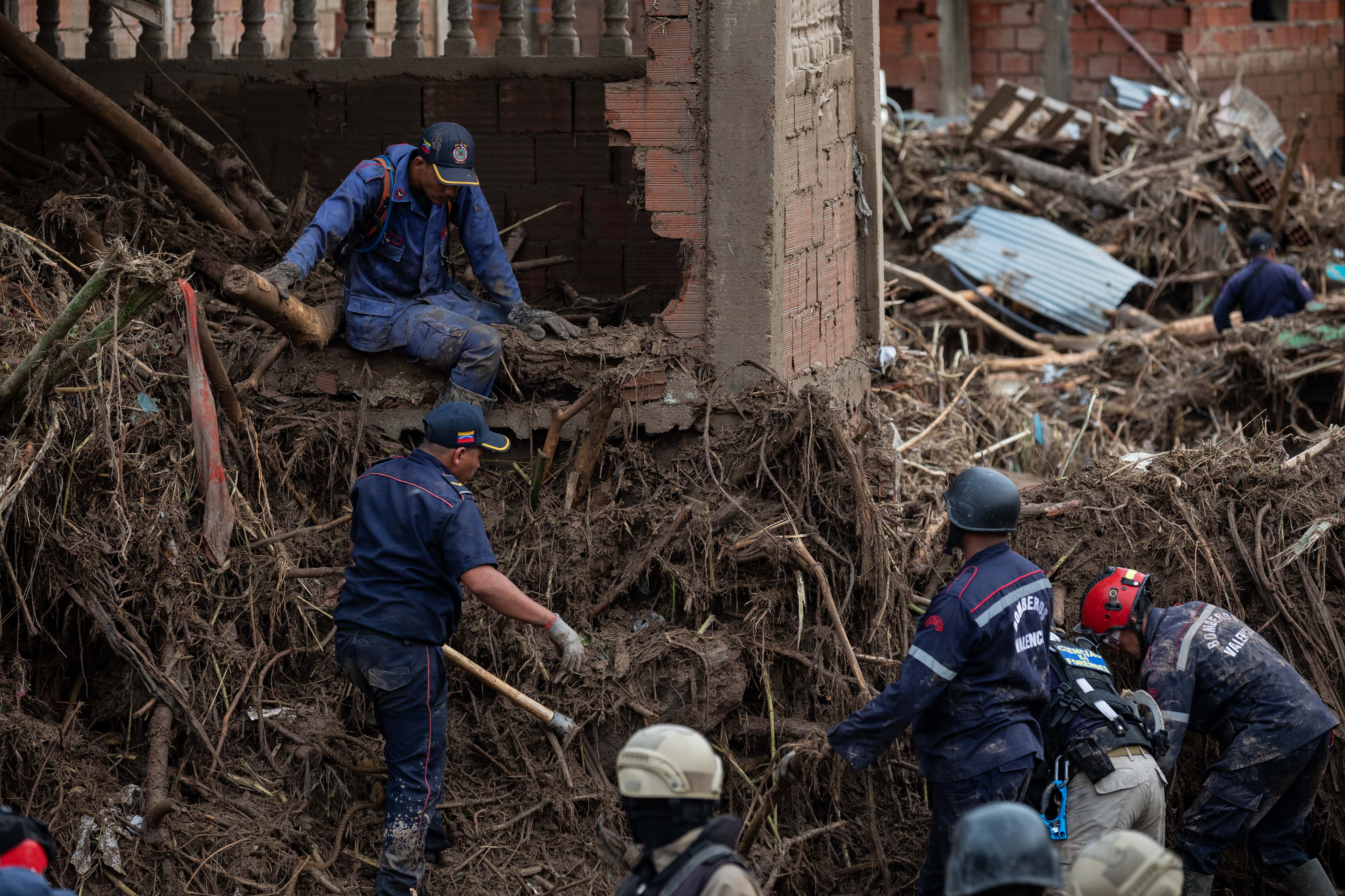 ACOMPAÑA CRÓNICA: VENEZUELA LLUVIAS***AME3304. LAS TEJERÍAS (VENEZUELA), 09/10/2022.- Rescatistas buscan hoy a los desaparecidos entre los escombros tras el desbordamiento de la quebrada Los Patos, en Las Tejerías, estado Aragua (Venezuela). Algunos habitantes de Las Tejerías, en la zona central de Venezuela, recuerdan este domingo los gritos de la tragedia, mientras otros son incapaces de describir la noche del sábado, cuando esta pequeña ciudad fue arrasada por una quebrada desbordada, que se llevó a más de un centenar de personas, de las que, al menos, 25 murieron y más de 50 siguen desaparecidas. EFE/ Rayner Peña R
