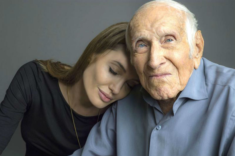 Fotografía facilitada por Universal Pictures de la actriz Angelina Jolie que posa junto al atleta olímpico y héroe de guerra Louis Zamperini (Nueva York, 1917) en la primera imagen que ha facilitado la distribuidora Universal de "Unbroken", su segunda película como directora.