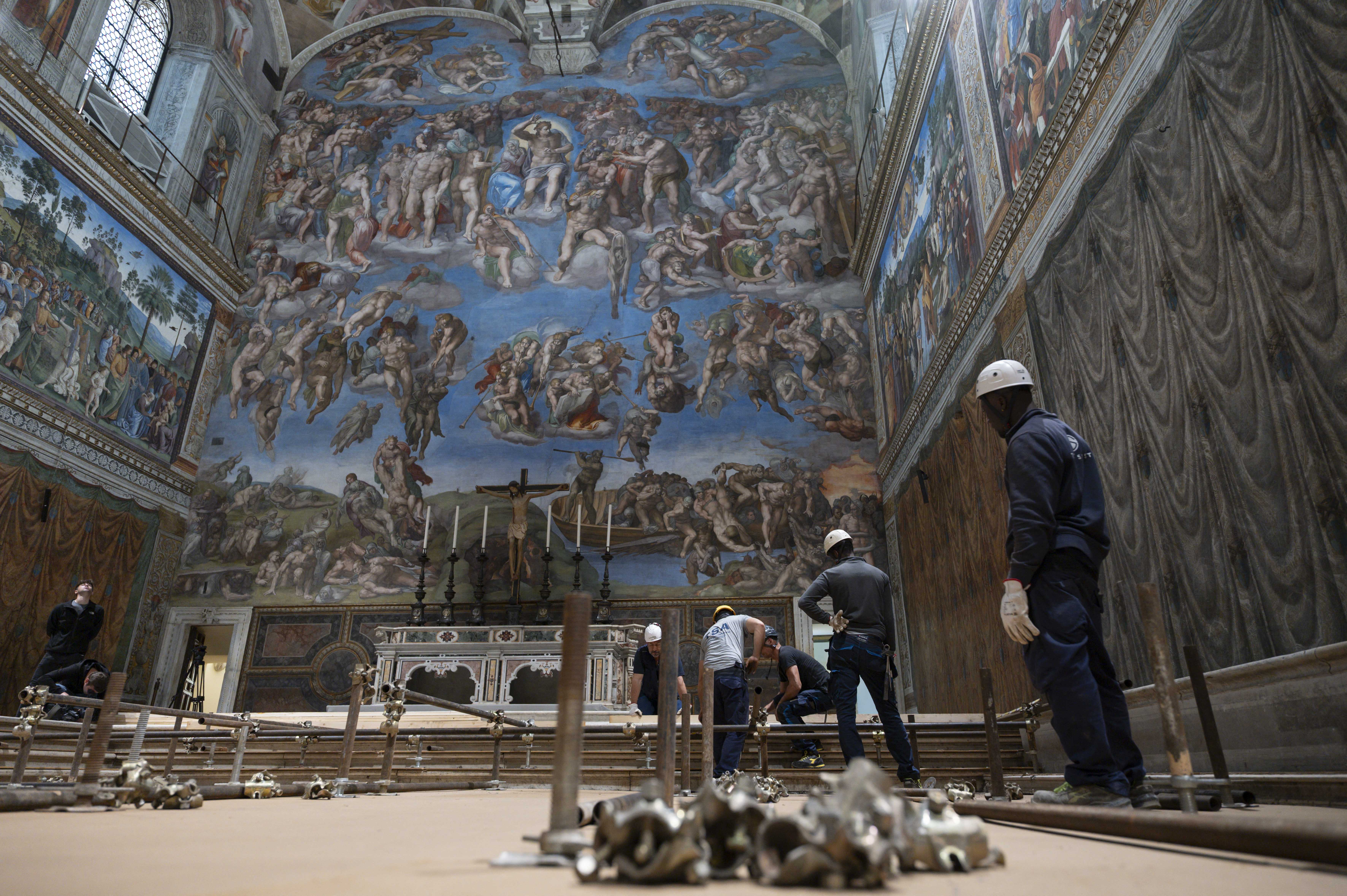 This photo handout on May 3, 2025 by The Vatican Media shows the setting up of the Sistine Chapel and installation of the chimney before the start of the conclave on May 7, 2025. (Photo by Handout / VATICAN MEDIA / AFP) / RESTRICTED TO EDITORIAL USE - MANDATORY CREDIT "AFP PHOTO / VATICAN MEDIA" - NO MARKETING - NO ADVERTISING CAMPAIGNS - DISTRIBUTED AS A SERVICE TO CLIENTS