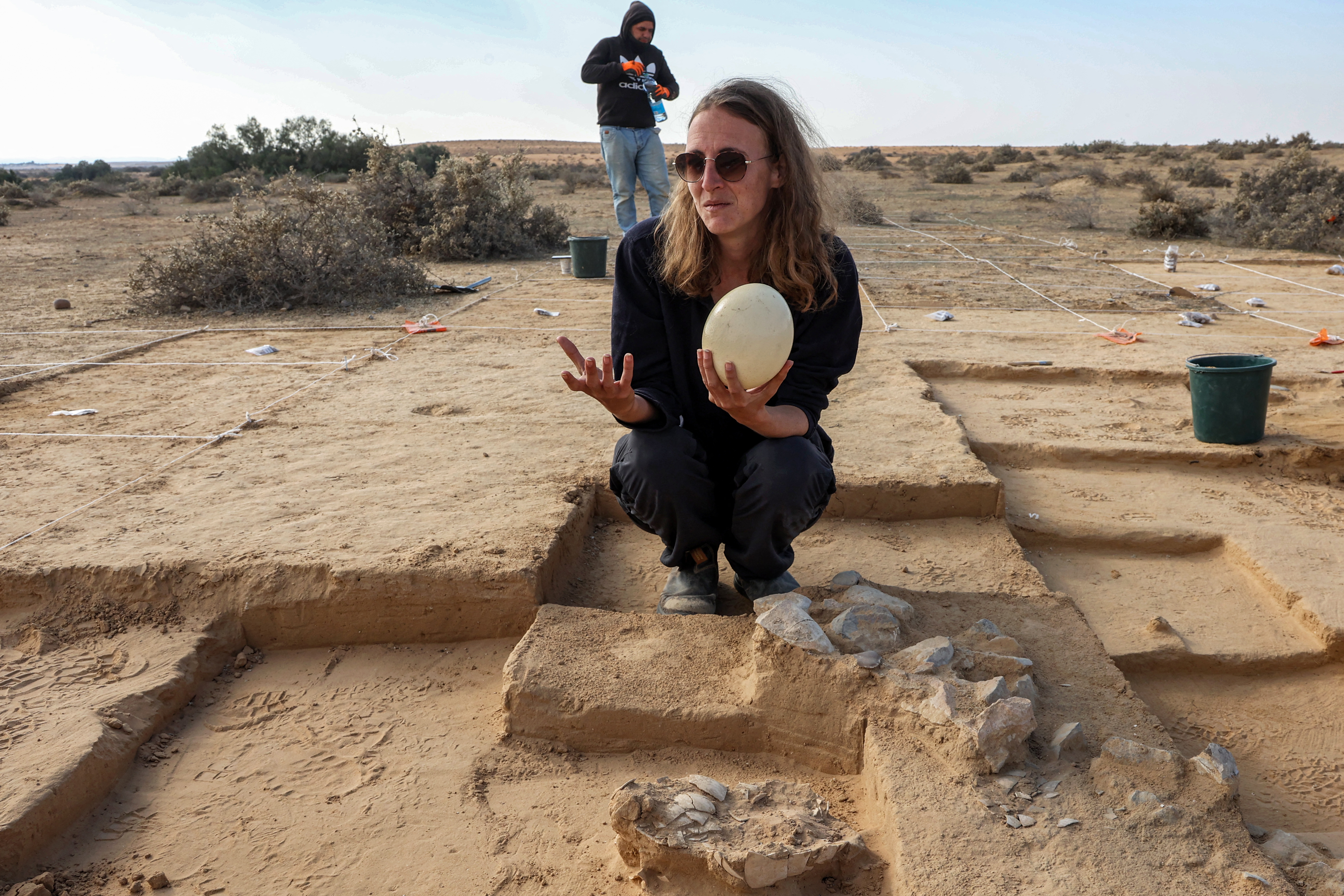 This picture taken on January 12, 2023 shows a view of discovered ostrich egg fragments dating over 4000 years discovered by the Israel Antiquities Authority (IAA) at a site in the dunes near Nitzana along the Israel-Egypt border in the western Negev desert. - Experts say the finds provide insight into the life of the ancient peoples inhabiting the region. The eight crushed eggs were located at a camp site used by nomads "since prehistoric times," said Lauren Davis, the Israel Antiquities Authority excavation director. Their proximity to the fire, alongside stones, flint, tools and pottery sherds, implies that the eggs were to be cooked, said Davis. (Photo by GIL COHEN-MAGEN / AFP)