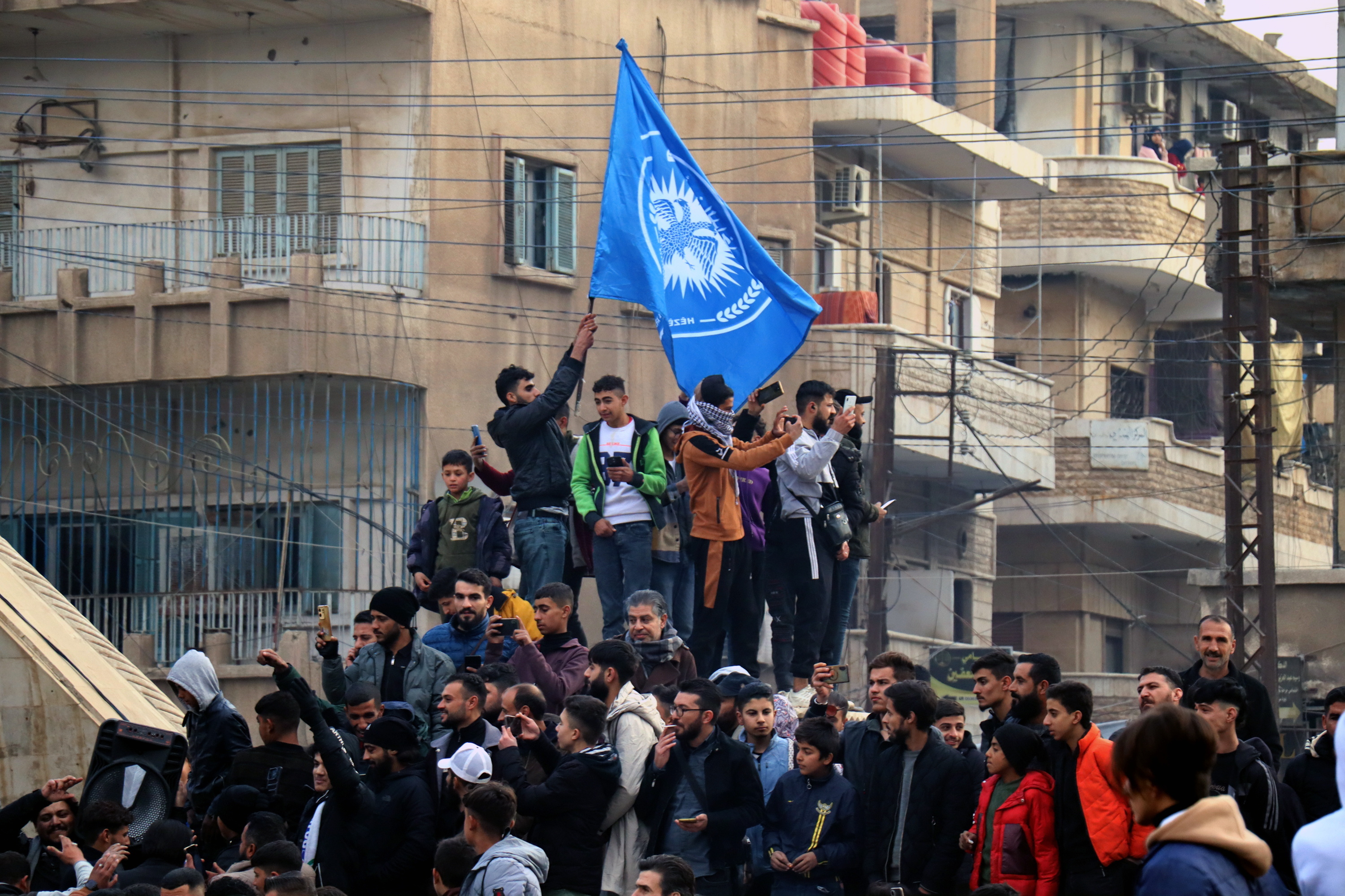 Al-hasakah (Syrian Arab Republic), 08/12/2024.- Syrian people celebrate at a square in central Hasakah after the Syrian Democratic Forces (SDF) took control of the city of al-Hasakah, northeast Syria, 08 December 2024. SDF Commander-in-Chief Mazloum Abdi said in a statement on 08 December that 'Syria is living historic moments as we witness the fall of the oppressive regime in Damascus'. Syrian rebels led by Hayat Tahrir al-Sham (HTS) entered Damascus on 08 December 2024 and announced in a televised statement the 'Liberation of the city of Damascus and the overthrow of Bashar al-Assad', as well as the release of all the prisoners. (Siria, Damasco) EFE/EPA/AHMED MARDNLI