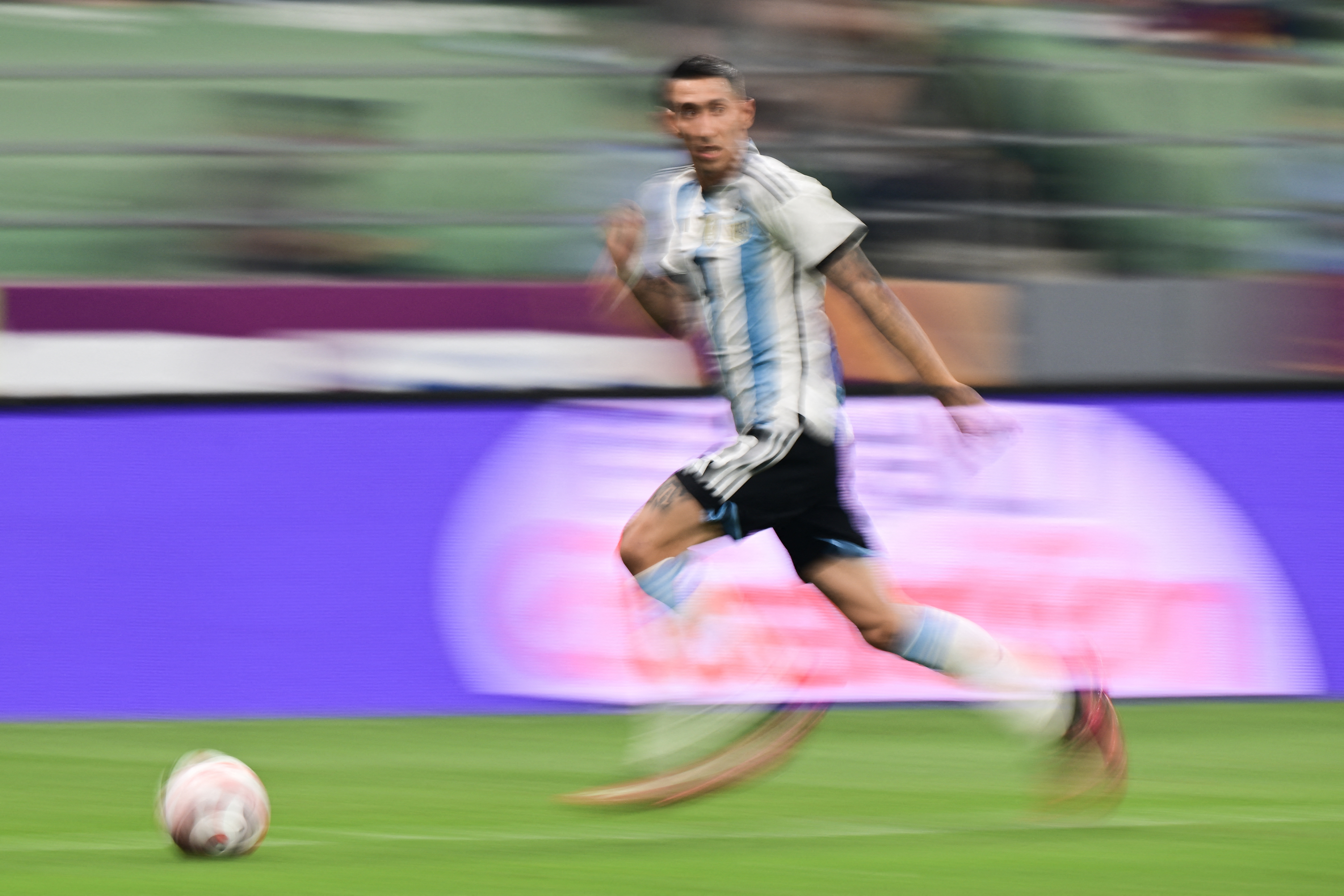 (FILES) Argentina's Ángel Di María runs with the ball during a friendly football match against Australia at the Workers' Stadium in Beijing on June 15, 2023.