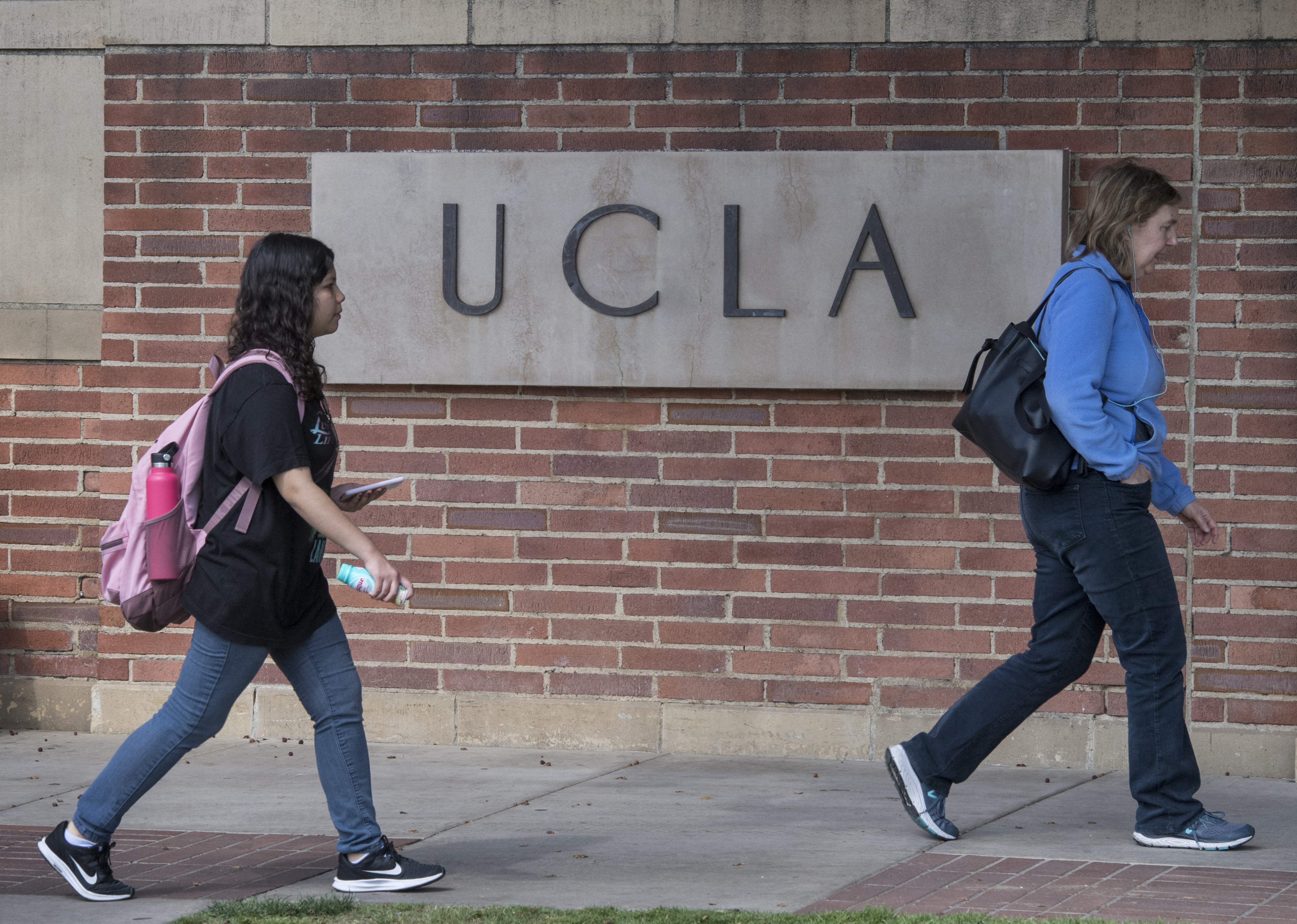 (FILES) People walk through the campus of the UCLA college in Westwood, California on March 6, 2020.