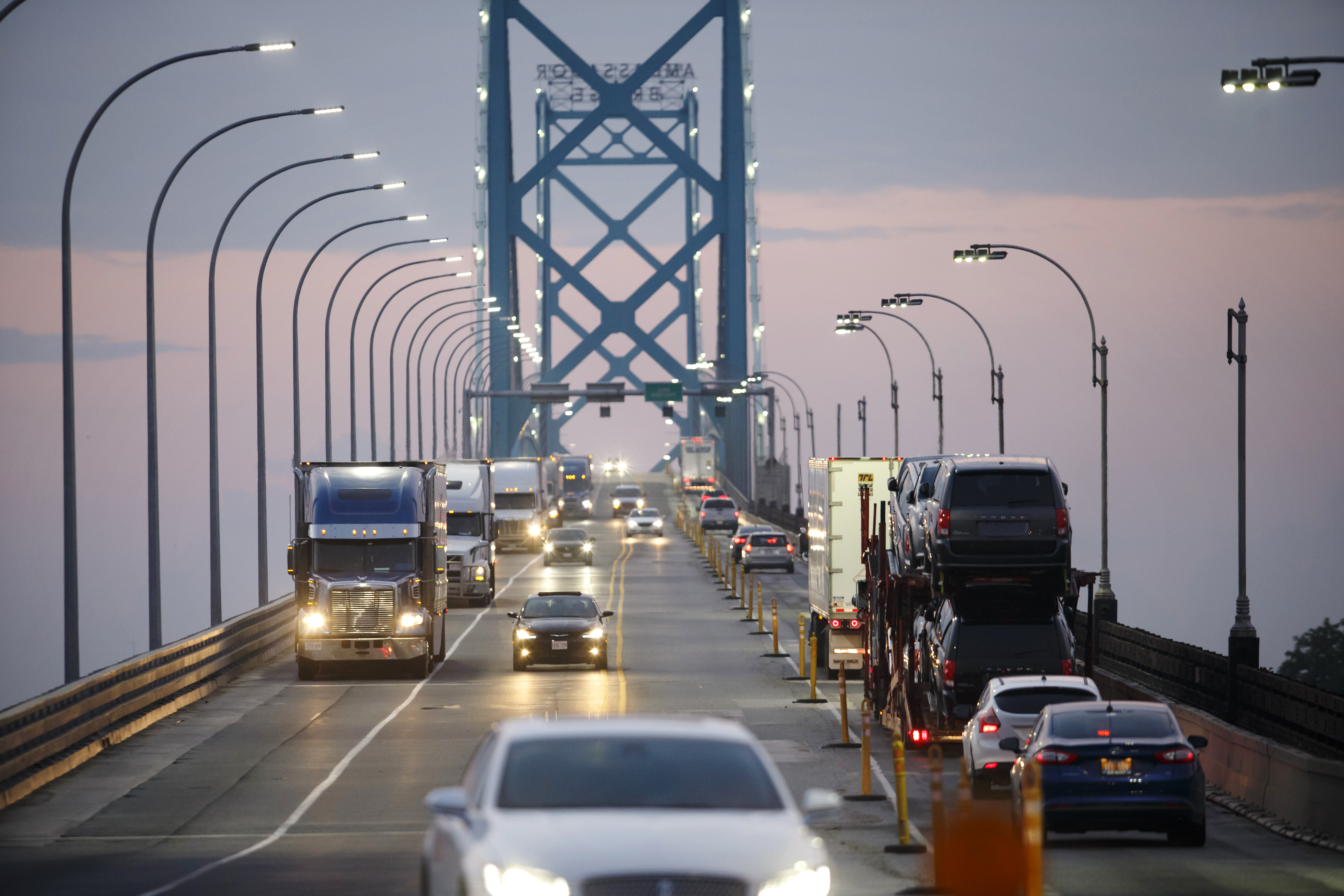 Vehicles drive across Ambassador Bridge on the Canada-U.S. border in Windsor, Canada. Photographer: Cole Burston/Bloomberg