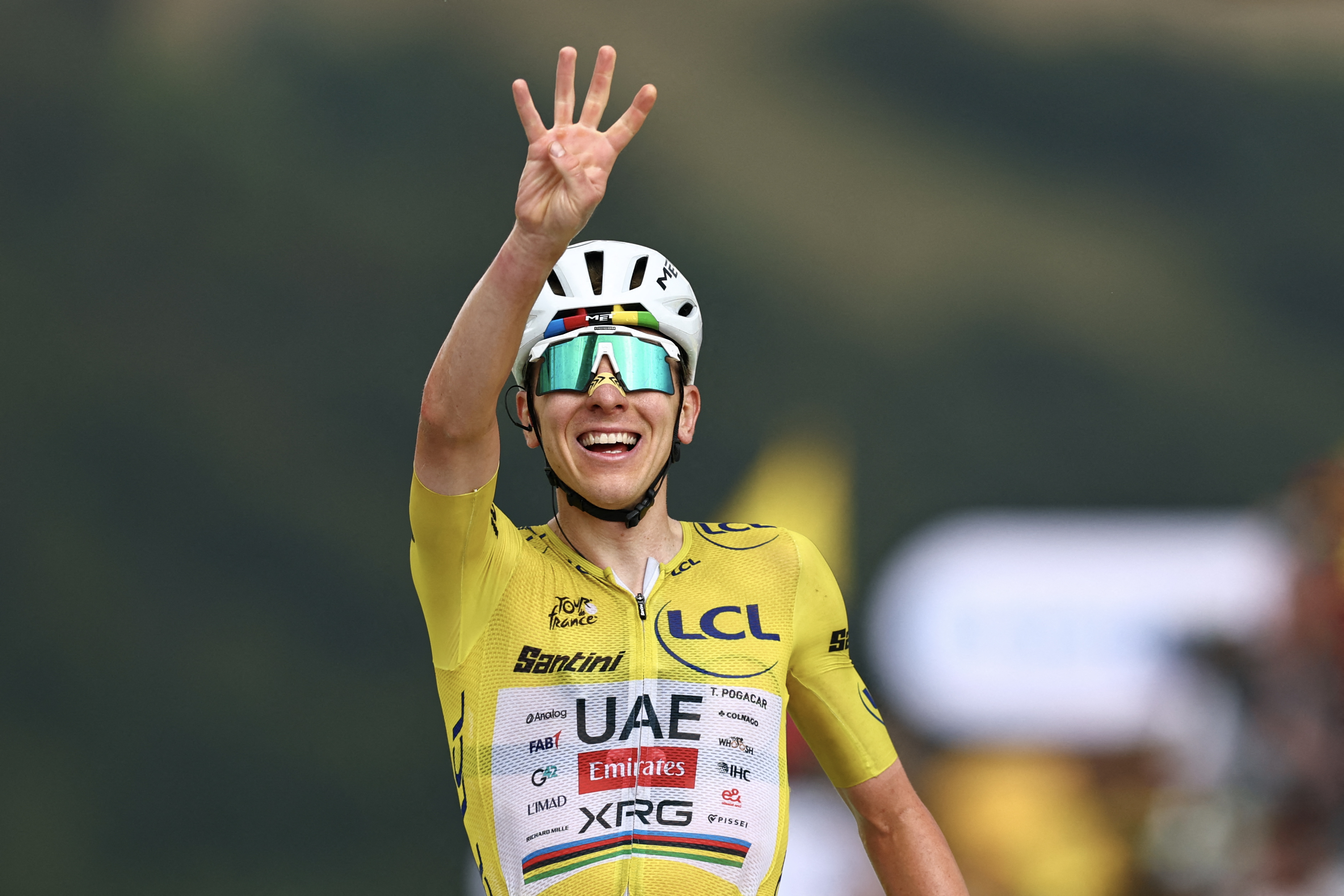 UAE Team Emirates - XRG's Slovenian rider Tadej Pogacar wearing the overall leader's yellow jersey cycles to the finish line to win the 14th stage of the 113th edition of the Tour de France cycling race, 155,3 km between Mulhouse and Le Markstein in the Vosges mountains, on July 18, 2026. (Photo by Anne-Christine POUJOULAT / AFP)