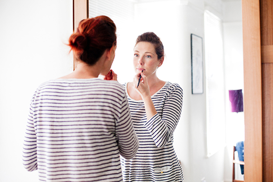 Woman applying make up