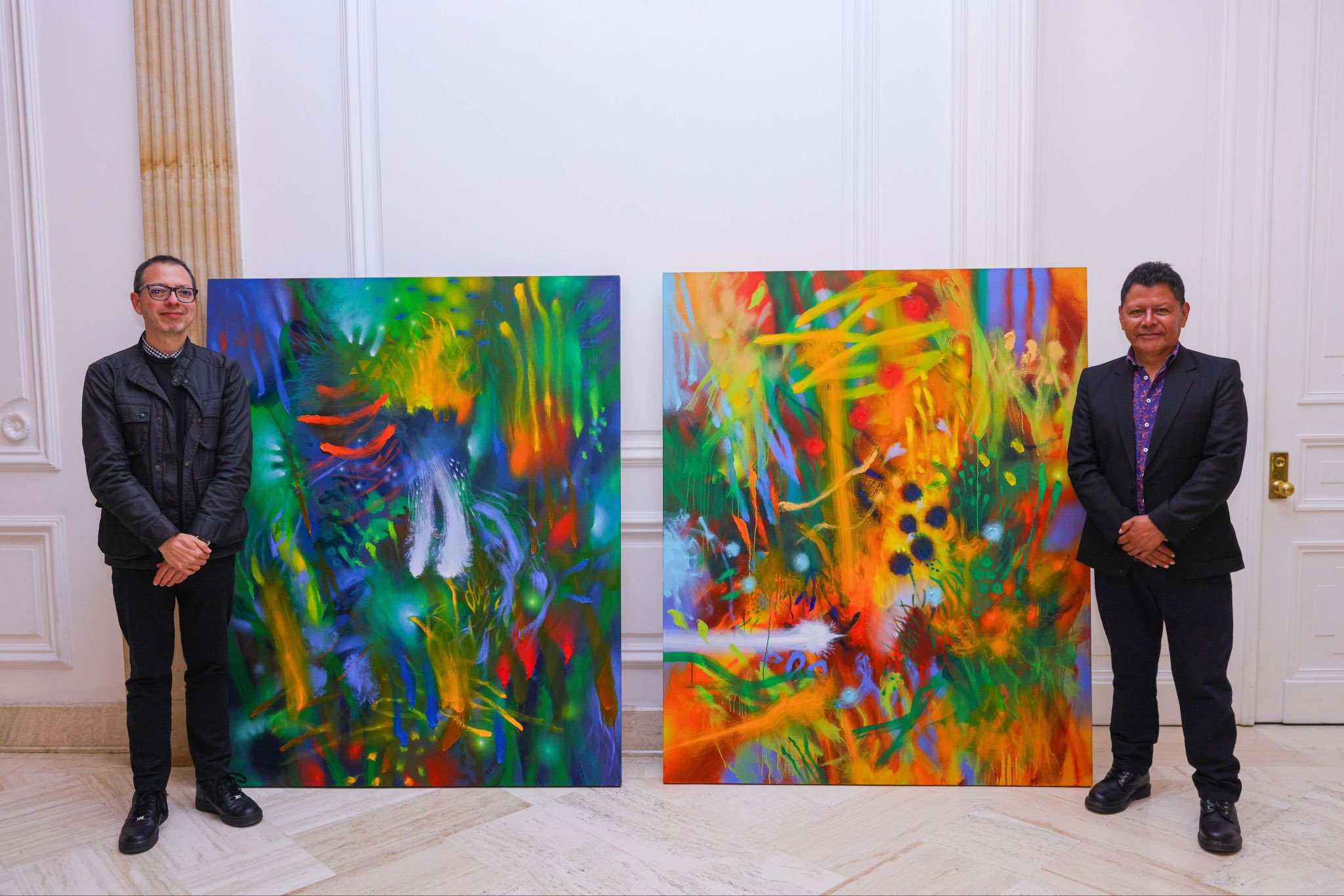 Las pinturas “Al comenzar el día” y “El amarillo antes del mediodía”, obras de Carlos Jacanamijoy, recibidas para el Palacio de Nariño por parte del ministro de las Culturas, Juan David Correa (izq.).