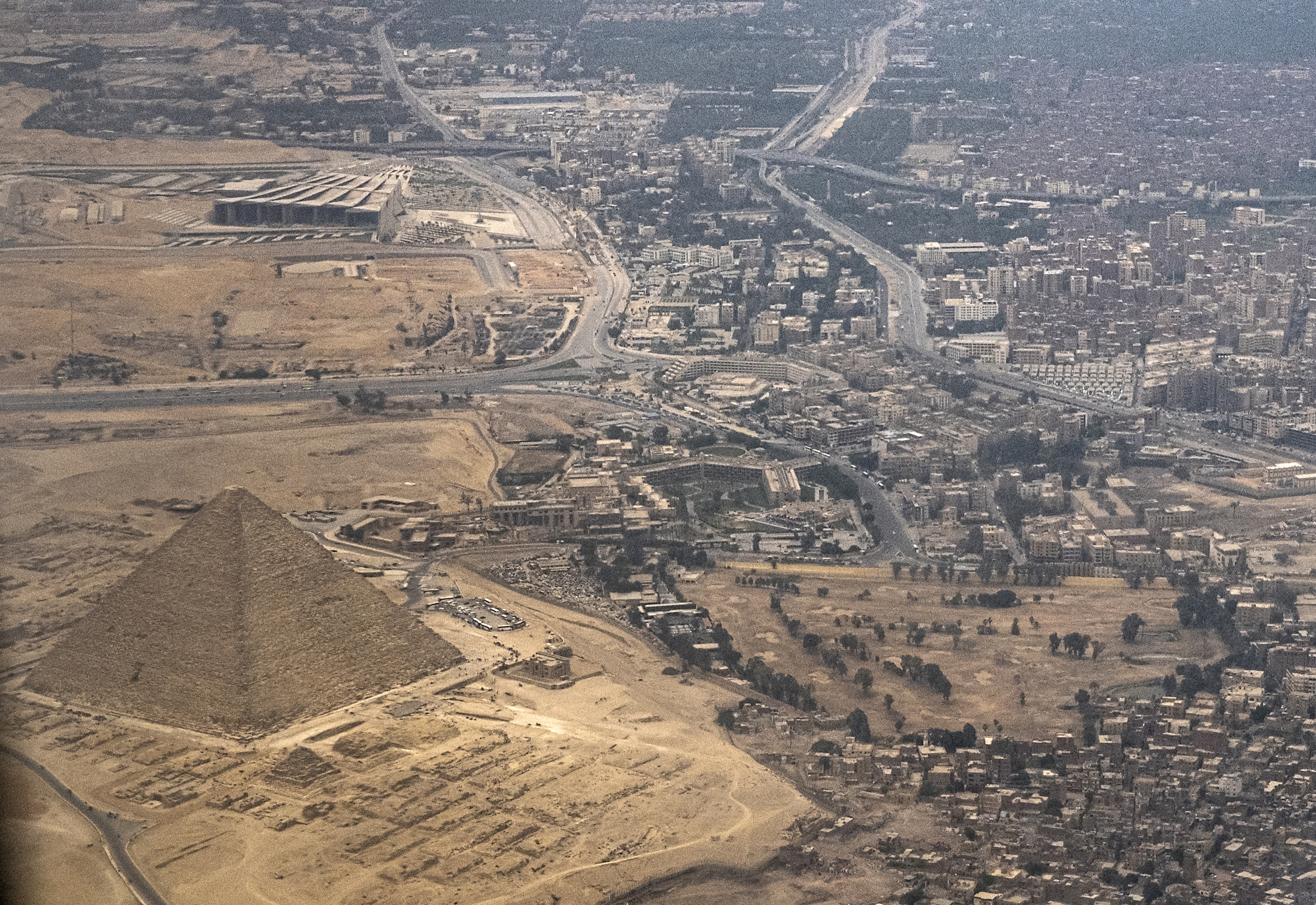 (FILES) This picture taken on April 22, 2022 shows an aerial view of (bottom-L) the Great Pyramid of Khufu (Cheops) and (top-L) the under-construction Grand Egyptian Museum (GEM),expected to be inaugurated later in the year, on the outskirts of Giza, the twin-city of Egypt's capital Cairo.